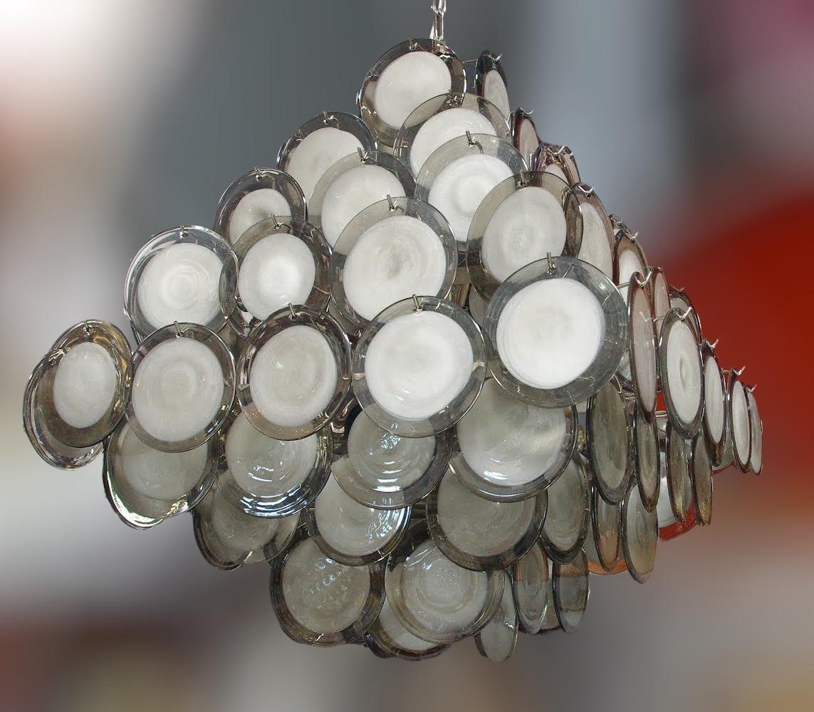 Italian modern Murano chandelier with smoky and white infused Murano glass discs hanging from a pyramid shaped chrome finish frame by Fabio Ltd / Made in Italy
12 lights / E26 or E27 type / max 60W each
Length: 30 inches / Width: 30 inches / Height:
