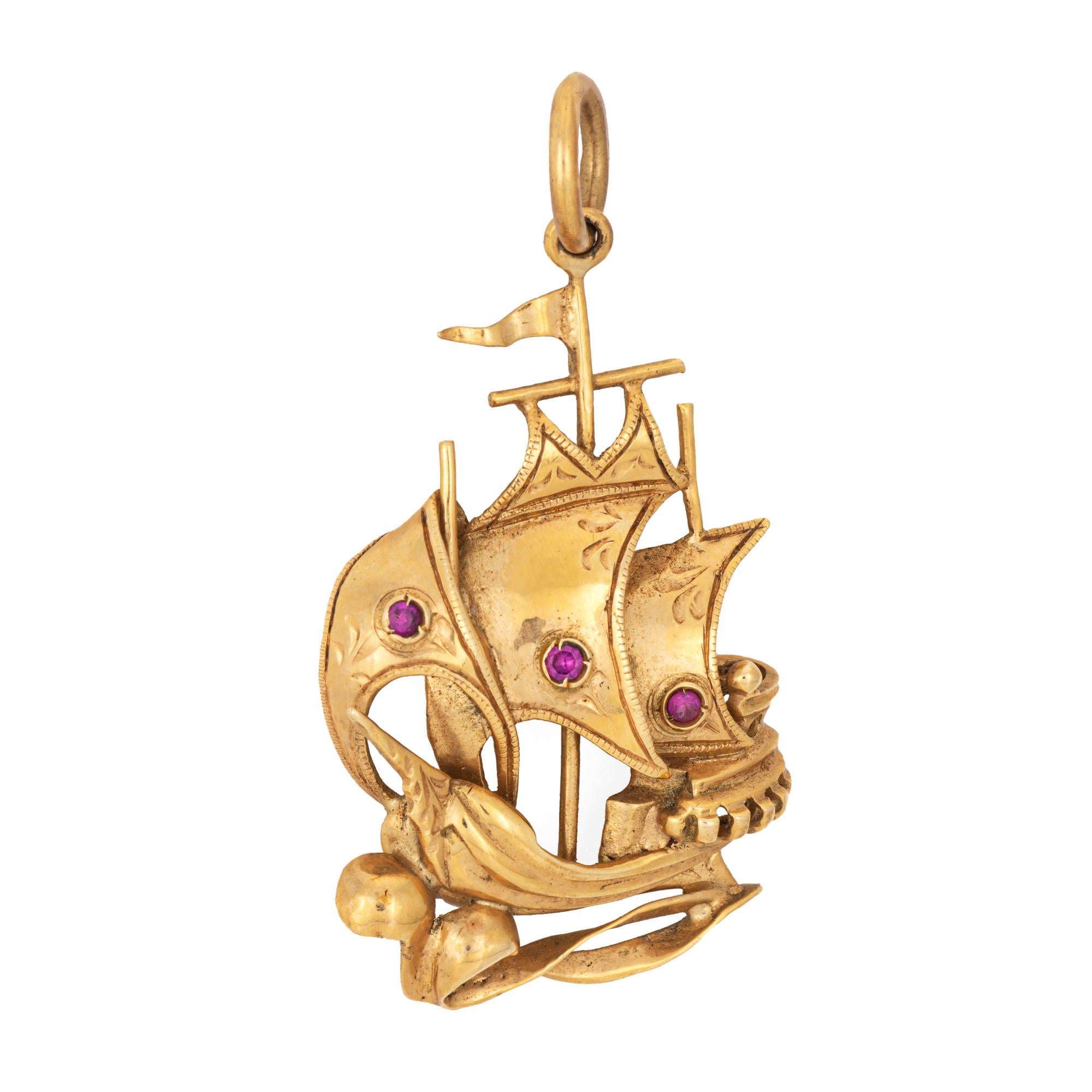 Finely detailed vintage ship charm crafted in 18k yellow gold (circa 1960s).  

Three small rubies measure approx. 1mm. 

Sail away! The lifelike pendant has been designed as if the wind is catching the sails as the ship forges ahead in the ocean.
