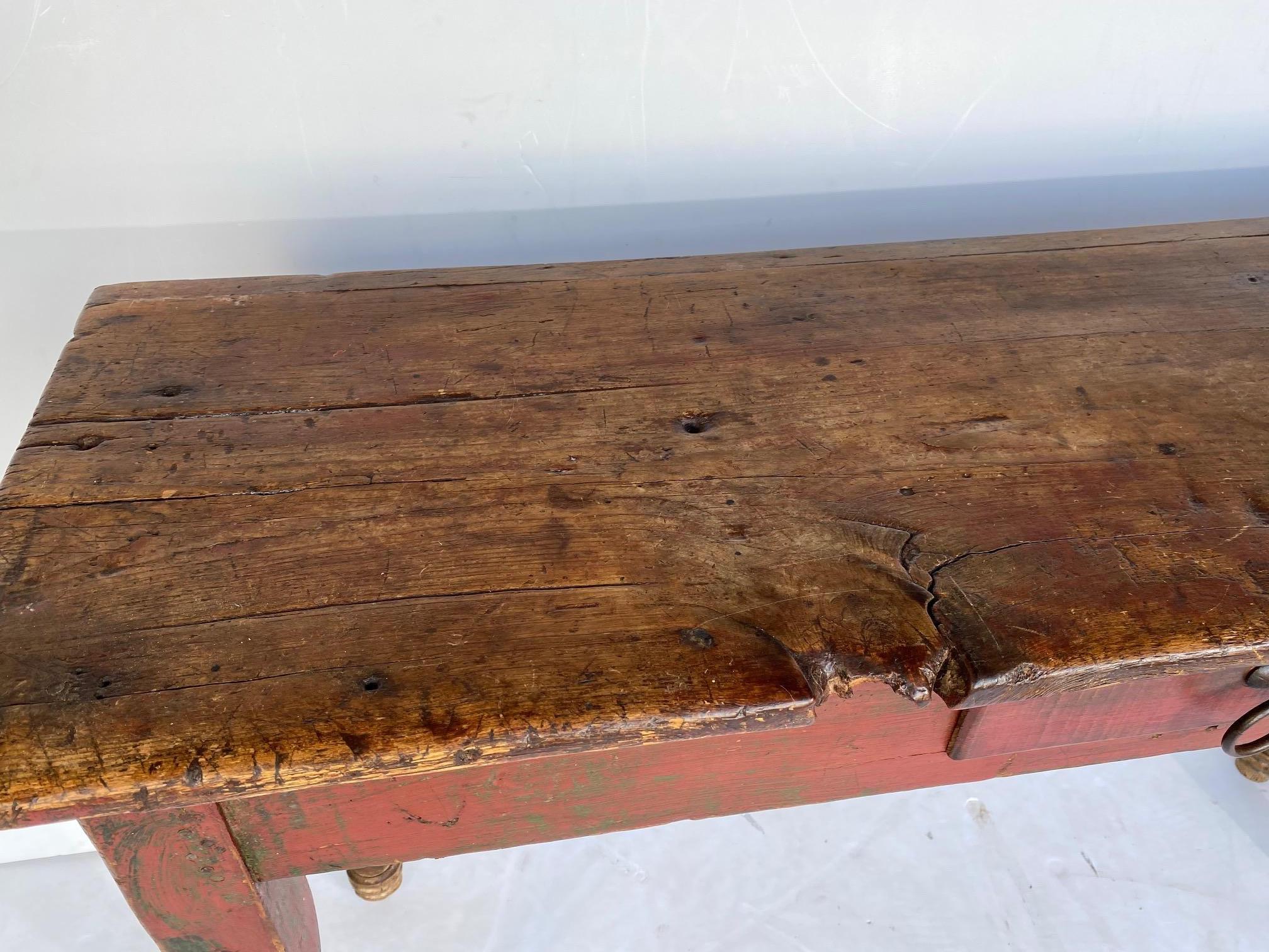 A primitive console table with a single drawer.