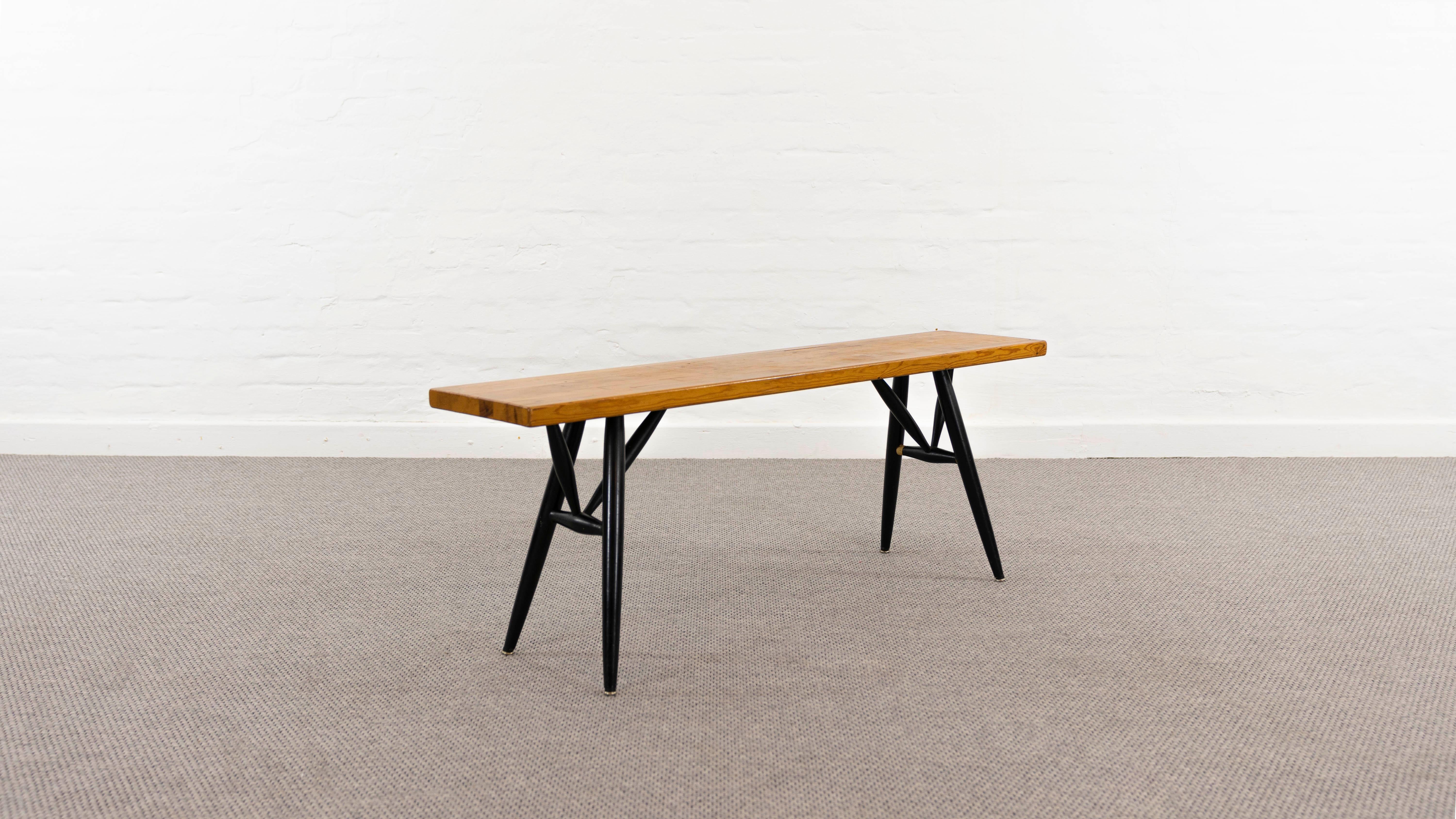 Mid Century Pirkka Bench. Designed by Ilmari Tapiovaara 1955, manufactured by Laukaan Puu, Finland. Pine seat and the legs are made from black lacquered beech. Signed underneath with brand stamp.