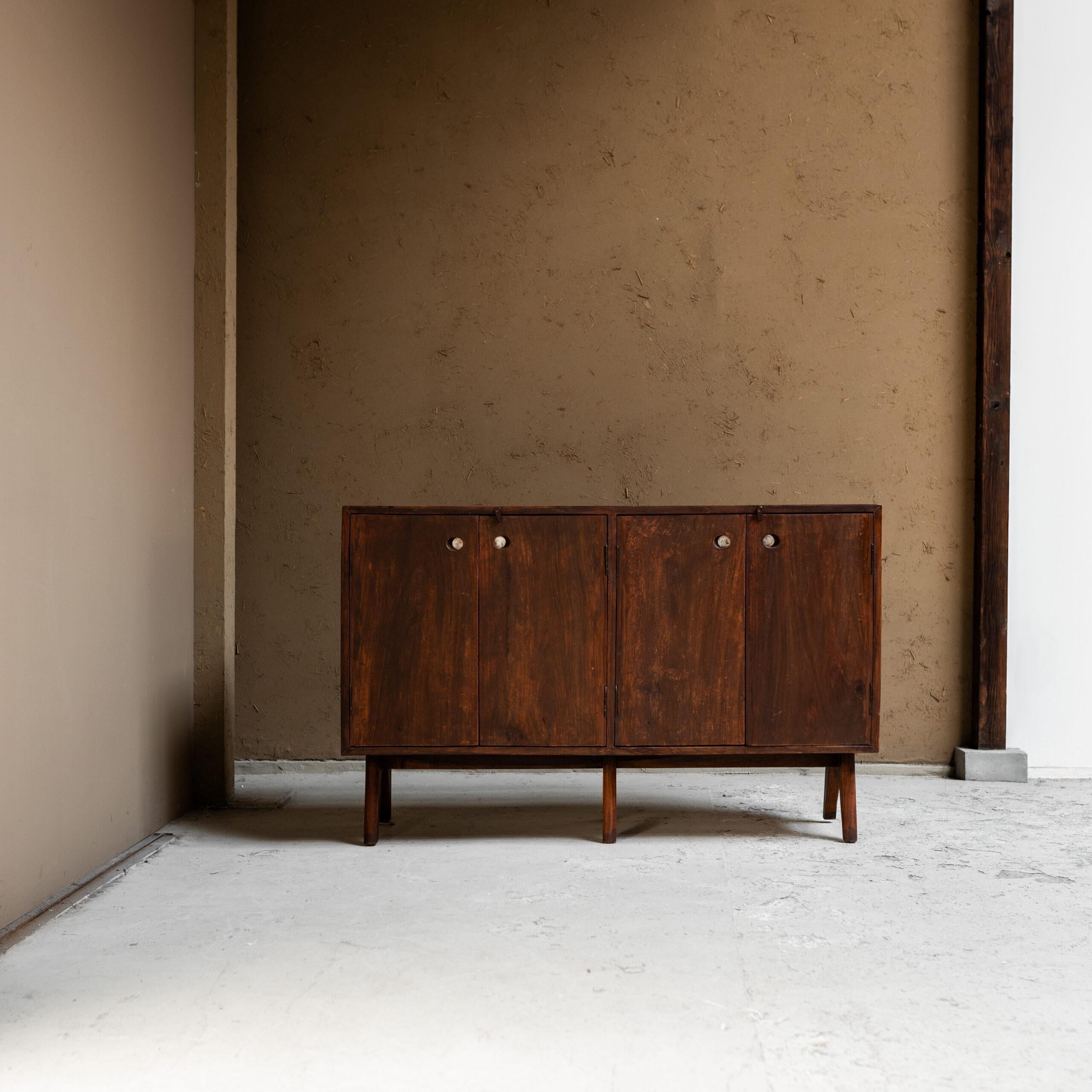 A rare and authentic example from the Chandigarh project in India, this teak low cupboard by Pierre Jeanneret reflects the architect’s rational yet sculptural design language. Characterized by its solid teak construction.

The design embodies