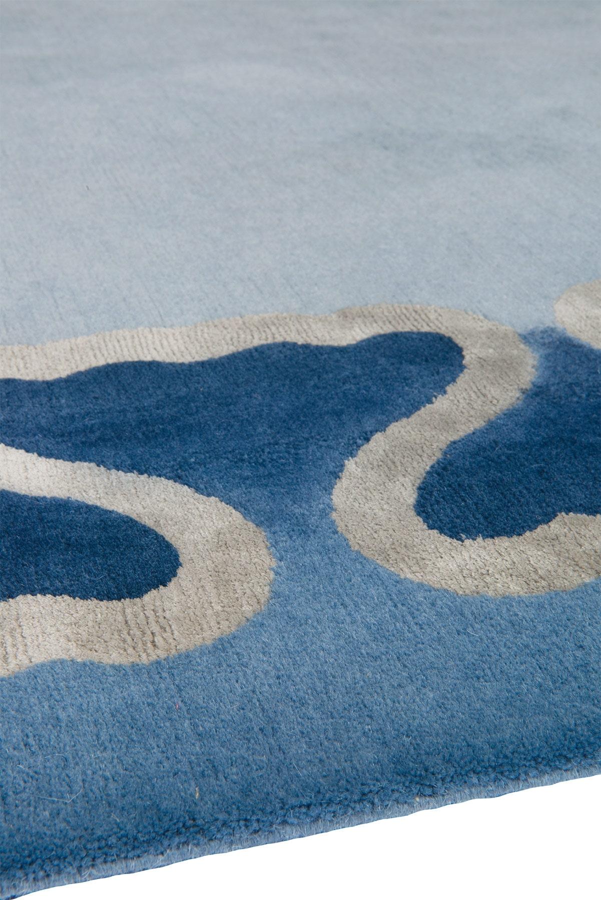 Characterised by its aquatic nature, Pisces presents an ornamental fishtail border. Accents of gold silk are complemented by a deep blue ombre effect, accentuating the sense of waves rolling around the border of the rug.
  