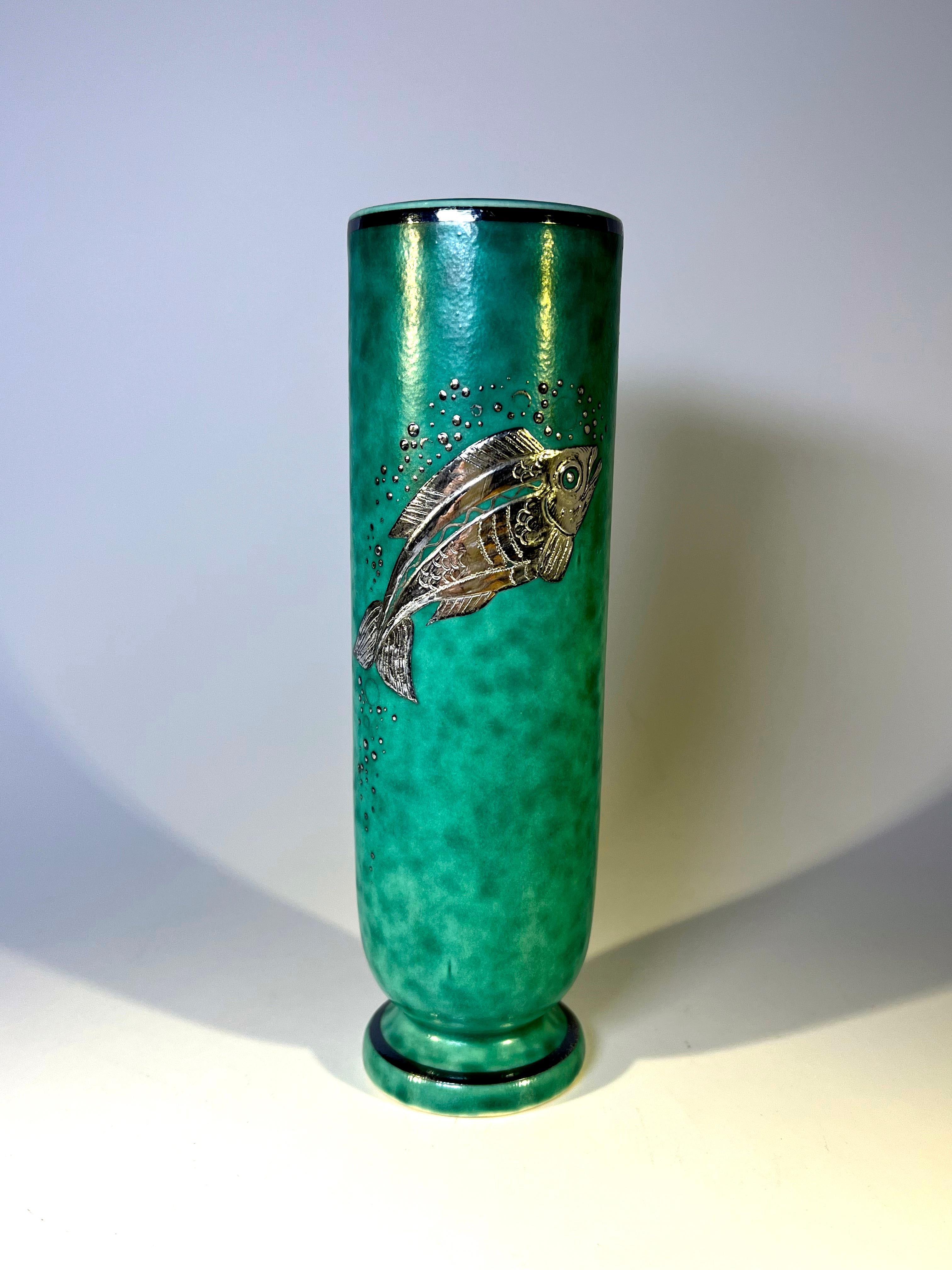 Superb bijou vase by Wilhelm Kage for Gustavsberg, Sweden from the Argenta collection.
Decorated with a stylised fish of applied silver on mottled green stoneware.
Circa 1930's
Base marked in silver paste, Gustavsberg Argenta 1029 II Made in