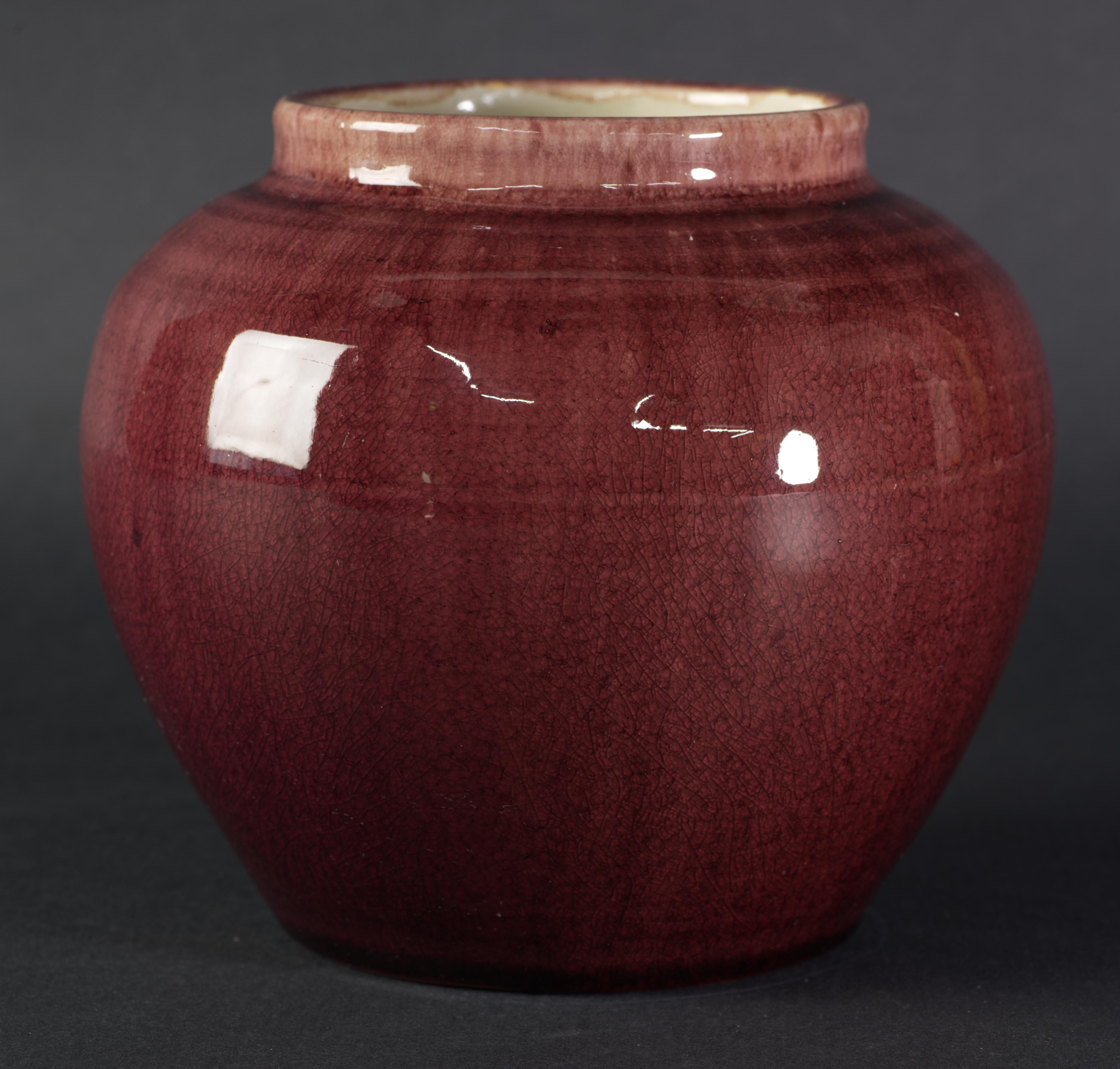  Beautiful rounded vase is decorated with light to dark oxblood red ombre craquelure glaze; the glaze is in high gloss finish and is smooth to the touch. The inner surfaces are finished with semi-gloss off-white glaze.

The vase is in good vintage