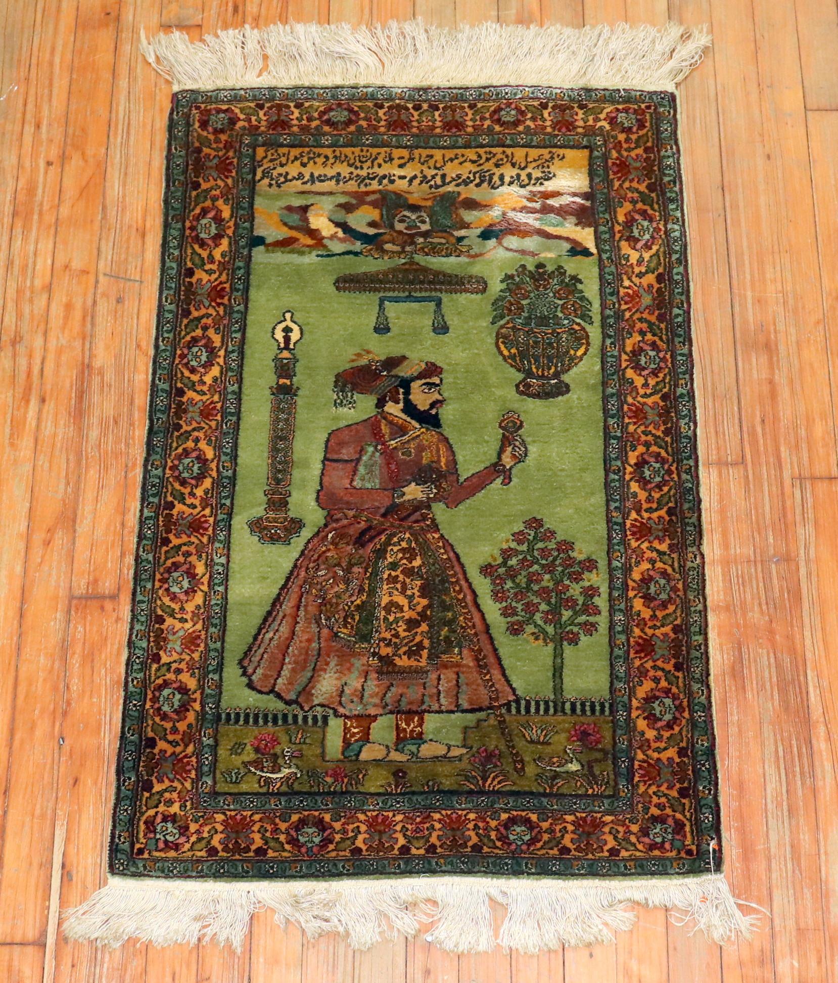 Handwoven silk Indian rug with an Indian Emperor on a pistachio green field. There is Arabic inscription.  King Aunshirvan was know for being just. 
 If you look over the kings head there is a scale.  Excellent condition.

Khosrow I, byname Khosrow