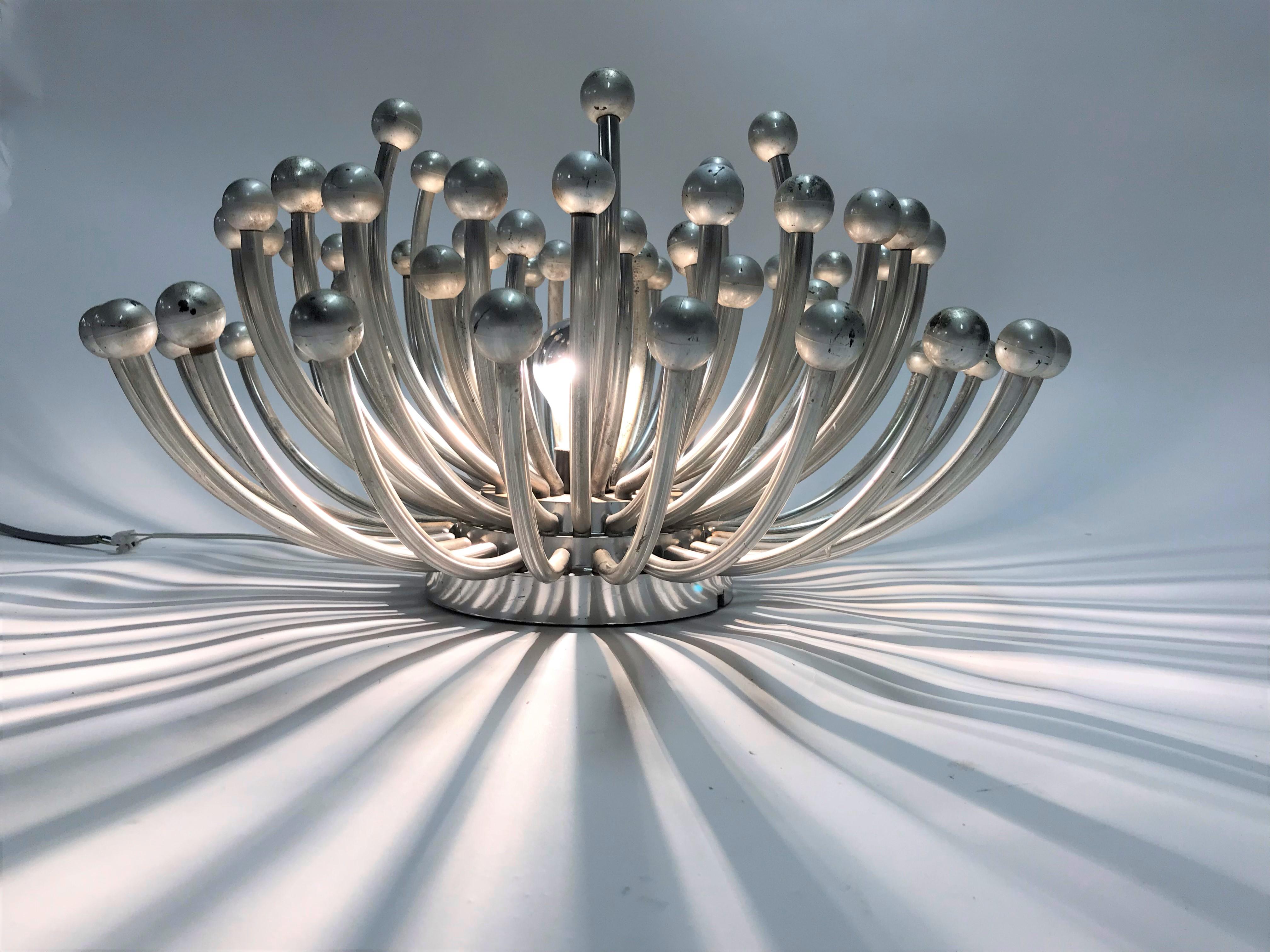 Stunning Pistillo sputnik lamp designed by Studio Tetrach.

This lamp can be used as a table lamp or even as a wall or ceiling light.

It emits a spectacular light.

Good condition, slight patina.

1969, Italy.

Measures: Diameter 60cm /