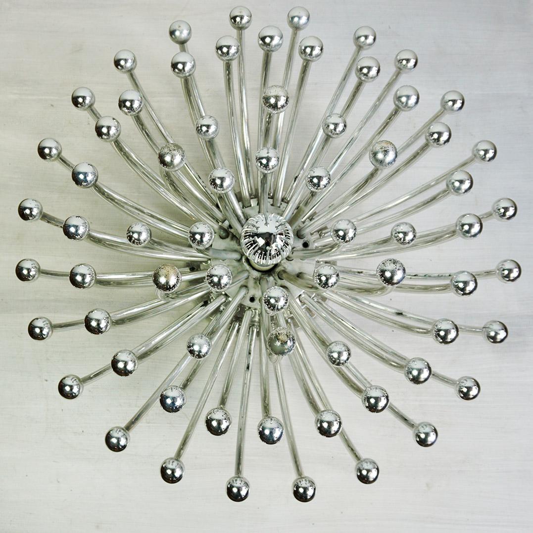 The iconic large Pistillo wall or ceiling lamp was designed by Studio Tetrarch for Valenti Italy in 1969 It is a masterpiece of Italian space-age design. Composed of radiant silver ABS plastic spokes that reflect light in all directions, it creates