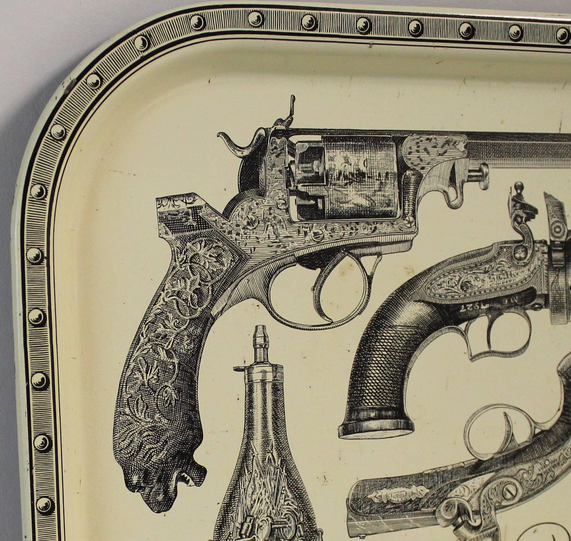 Plateau lacquered and silkscreened Mid-Century Modern metal tray with pistols attributed to Piero Fornasetti.