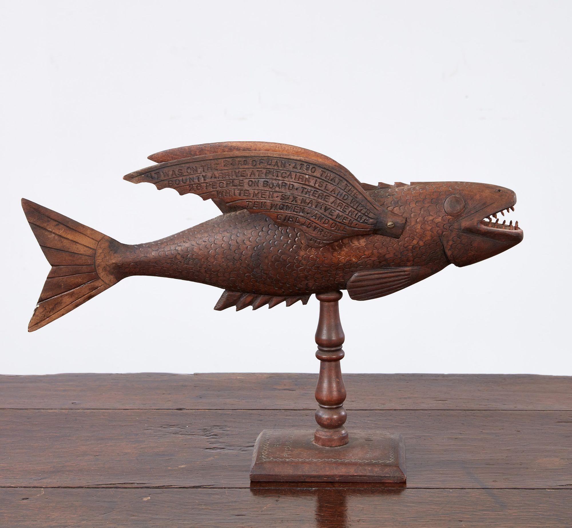 An impressive Pitcairn carved flying fish on stand having fins, scales and teeth, with stamped lettering to wings, of unusally large scale and possessing exceptionally fine patina.  