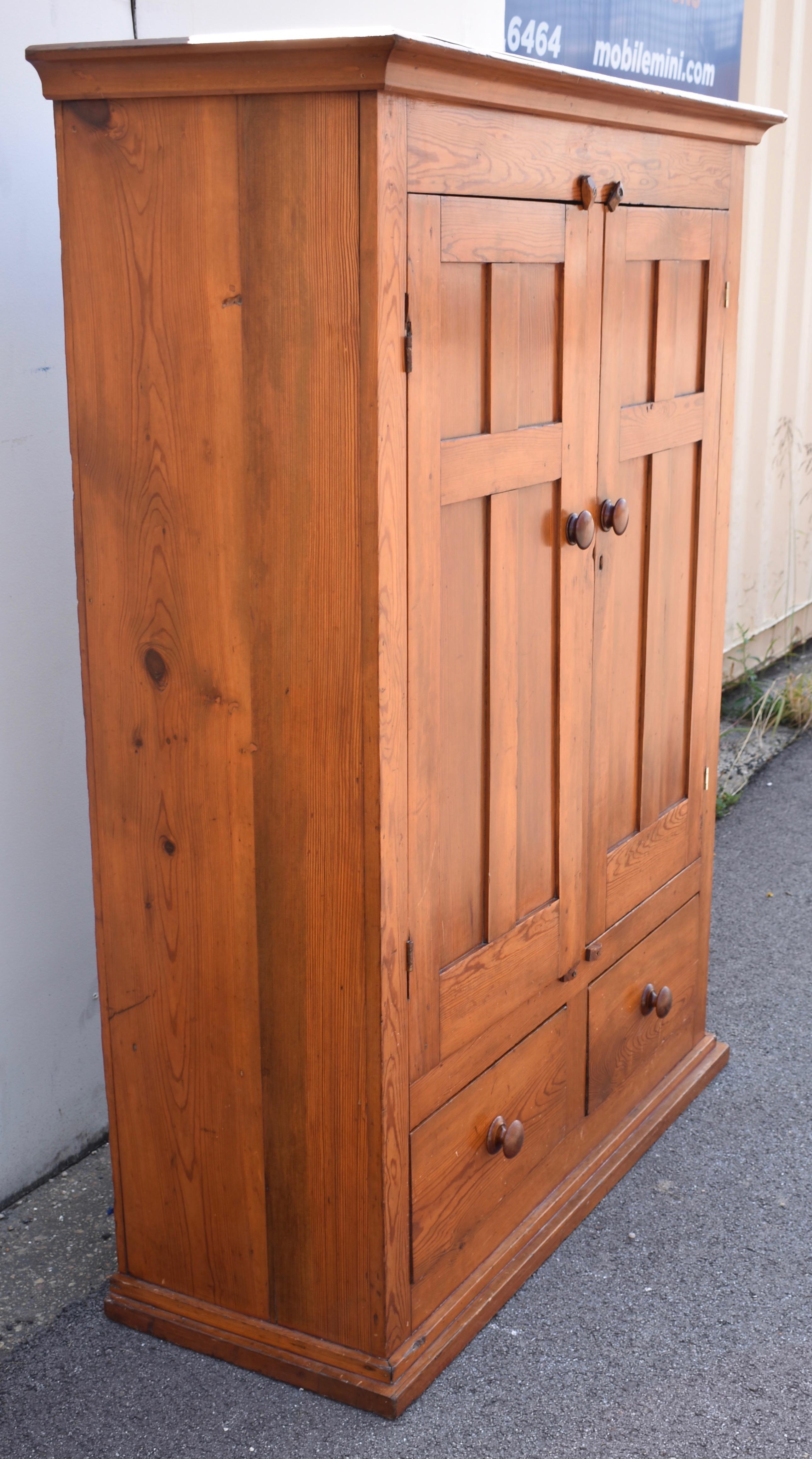 An attractive ogee crown molding is about the only curve on this handsome linen cabinet, otherwise comprised of straight lines and sharp corners.  Beneath the crown, a frieze showcases the swirling grain pattern typical of the pine variety known as