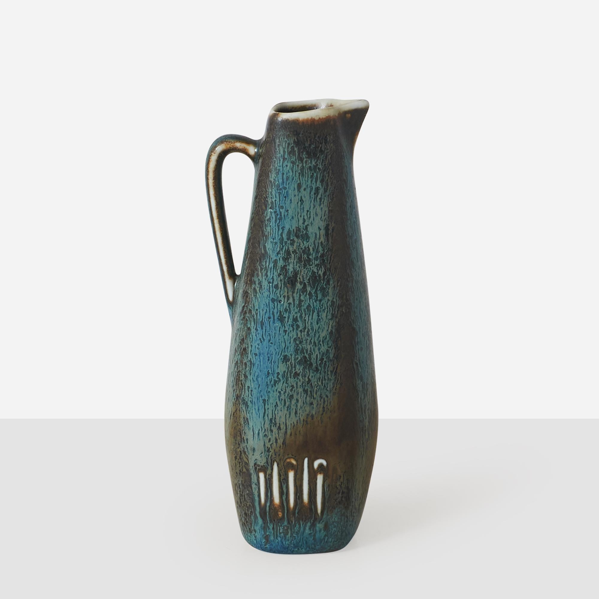 A very small pitcher or vase in hare's fur blue glaze by Gunnar Nylund for Rorstrand. Impressed on the bottom by both the creator and manufacturer's mark. 