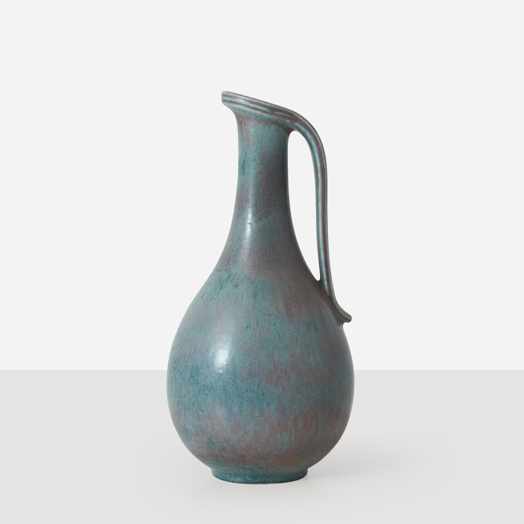 A small pitcher or vase in hare's fur blue glaze by Gunnar Nylund for Rorstrand. Impressed on the bottom by both the creator and manufacturer's mark. 