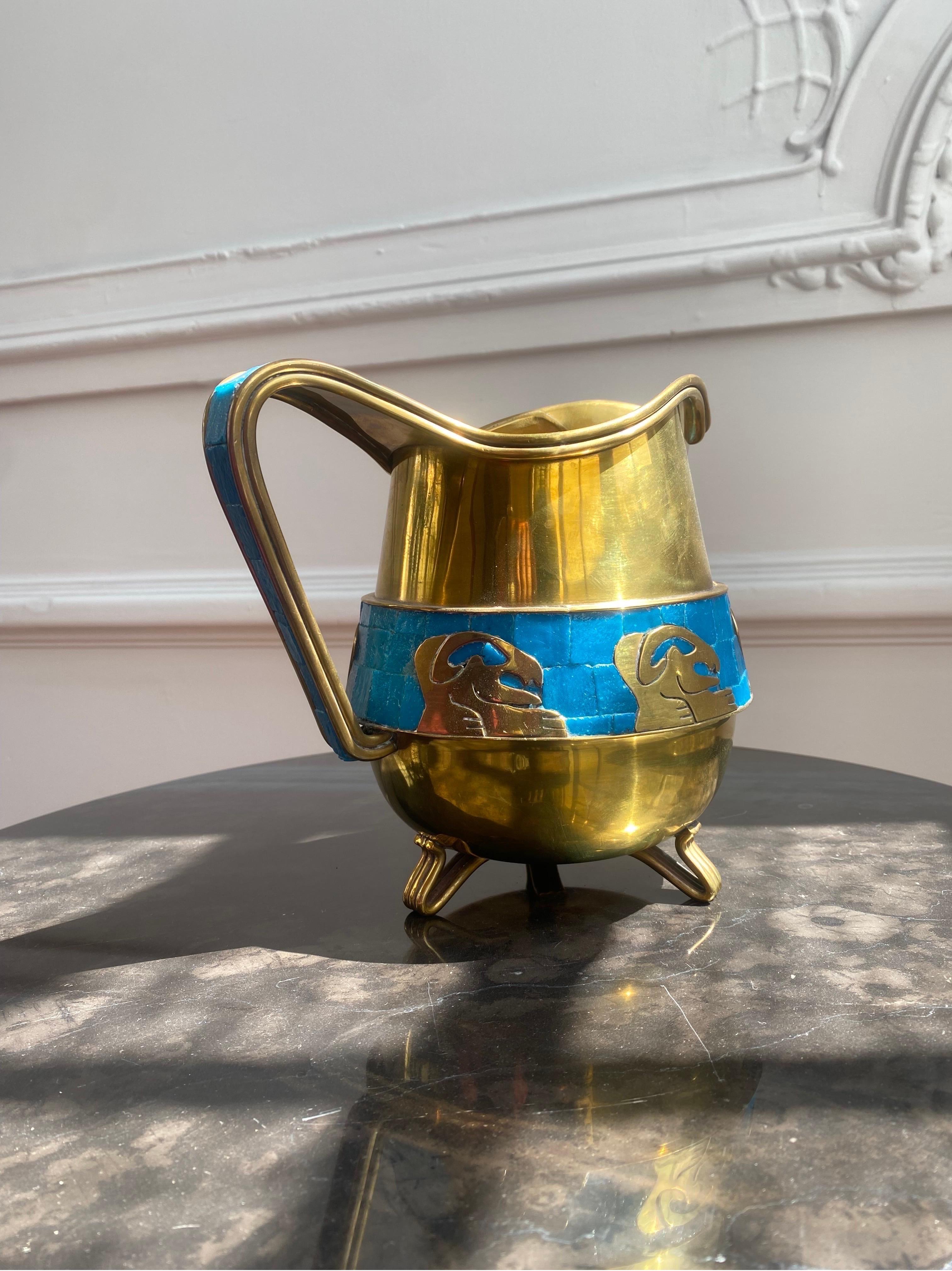 Beautiful and in very good condition pitcher designed by Salvador Terán. Made in Taxco, Mexico year 1960 in brass and glass mosiac. Designed with interesting figures and remarkable craftsmanship this pitcher is an eye catcher that represents part of
