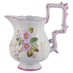 Pitcher in faience with motifs of flowers and insects. Style of Emile Gallé
