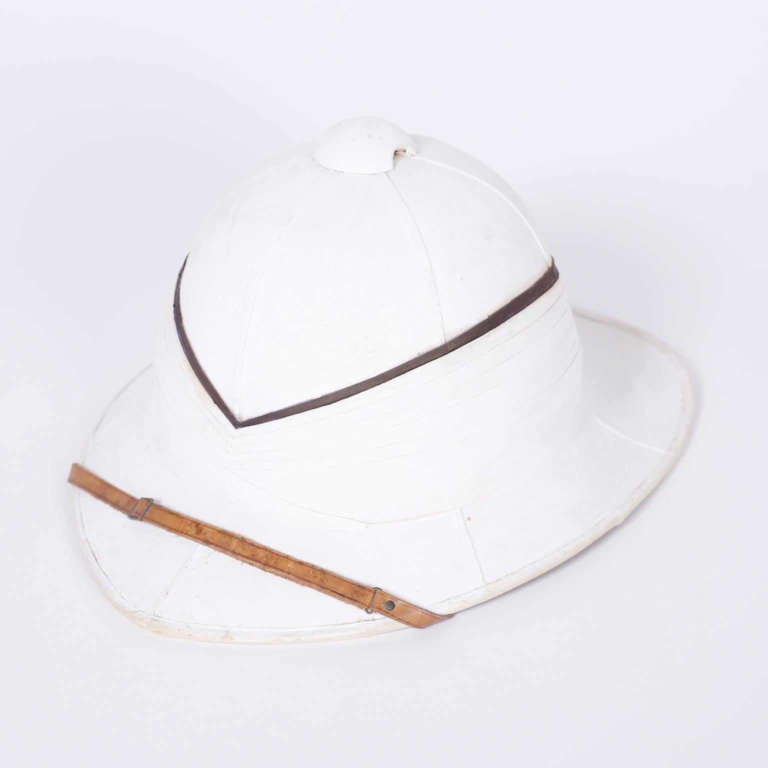 English pith helmet and painted copper box with all the historical romance you could wish for. Originally purchased from Gieves and Hawkes London by F.C.L. Halliday, a decorated Royal Navy officer in WWI.

Metal case measures: H 14, W 16, D