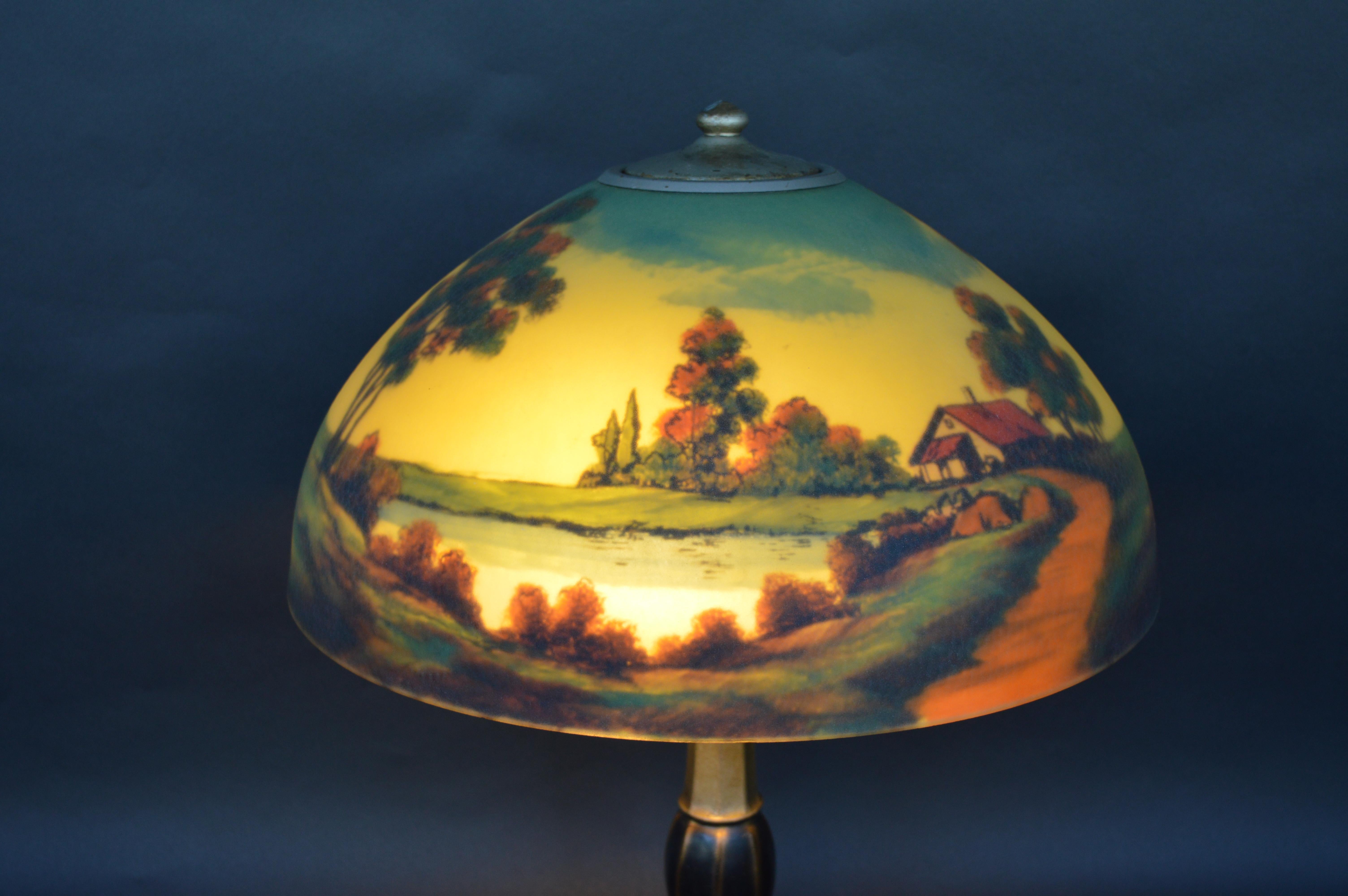 Pittsburg Jefferson lakeside cottage table lamp, circa 1900-1925
Reverse painted glass shade with painted iron base. Country lake scene landscape.