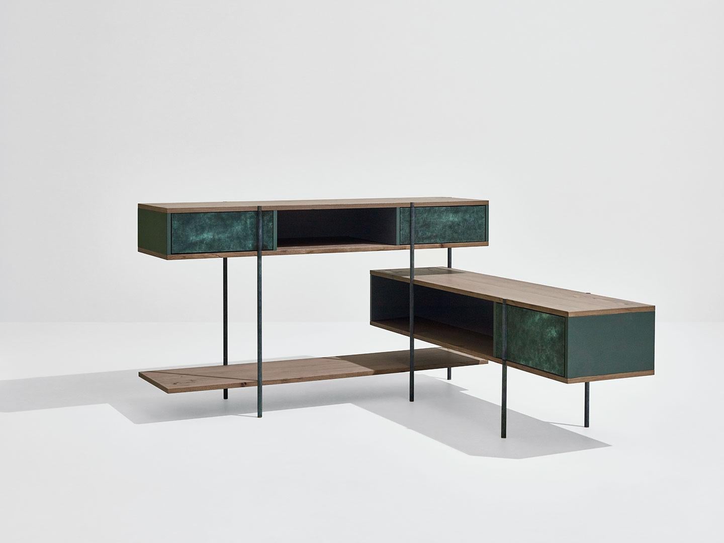 Pivot Angular console by SEM
Dimensions: W150 x D57 x H72 cm
Material:Metallic tubolar structure, Pivoting doors in surface in antique brass or patinas, Shelves in fossil elm or Canaletto walnut, Side and back panels in matt painted