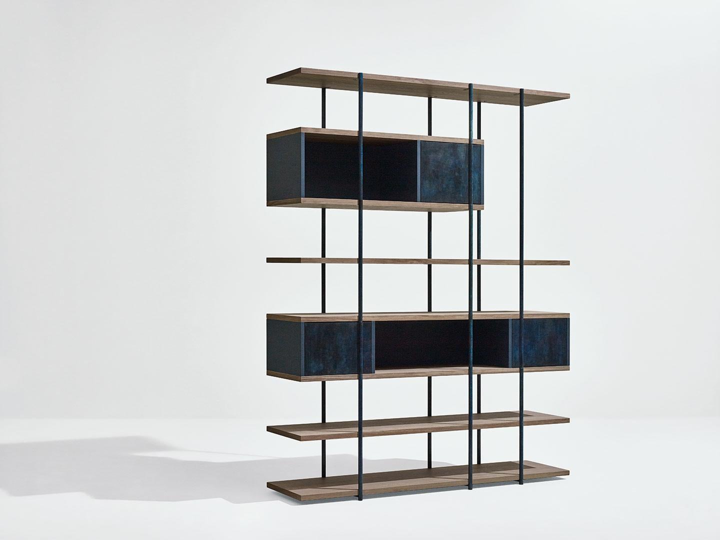 Pivot bookshelf by SEM
Dimensions: W156 x D38 x H203 cm
Material:Metallic tubolar structure, Pivoting doors in surface in antique brass or patinas, Shelves in fossil elm or Canaletto walnut, Side and back panels in matt
painted MDF. 
Available