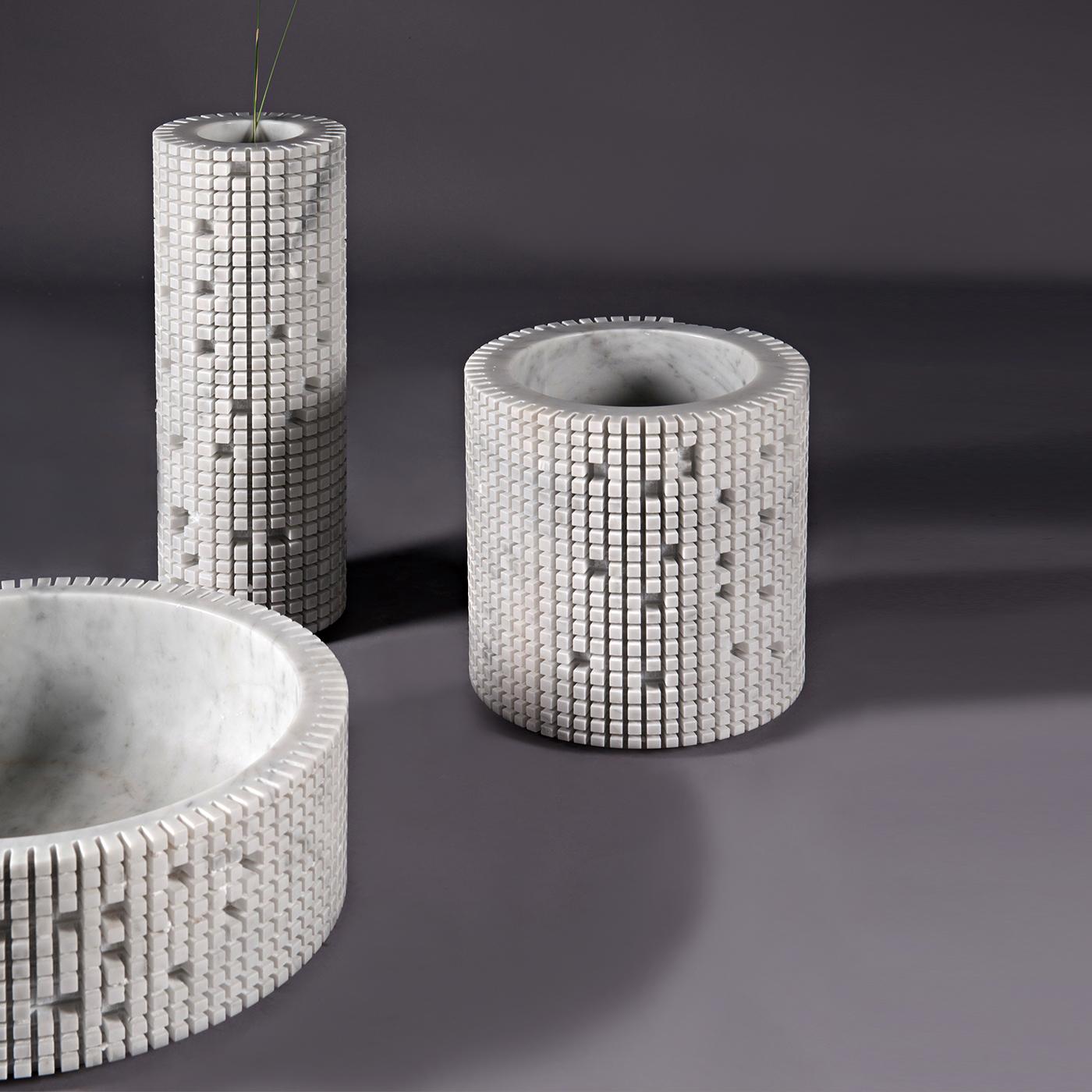 The medium-sized version of the Pixel design in white Carrara marble. Paolo Ulian used a single block to form the tall slim circular shape of the body and create the pixelated exterior that can be either kept or personalized by breaking off