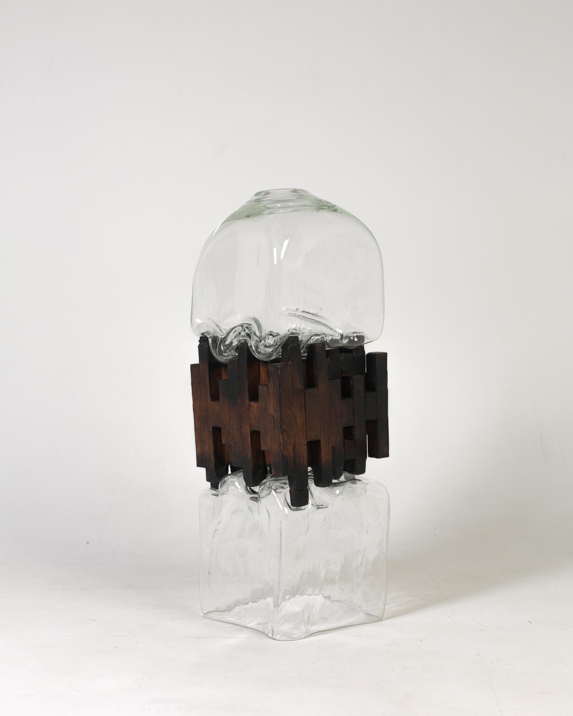 Pixel vase middle oak by Drozhdini
Dimensions: 80 x 23 x 23 cm
Materials: Glass, oak

Handcrafted by blowing with a glass tube. Glass was molded on uniformly fading, oak, as a result of which the moment of contact of plastic living glass matter