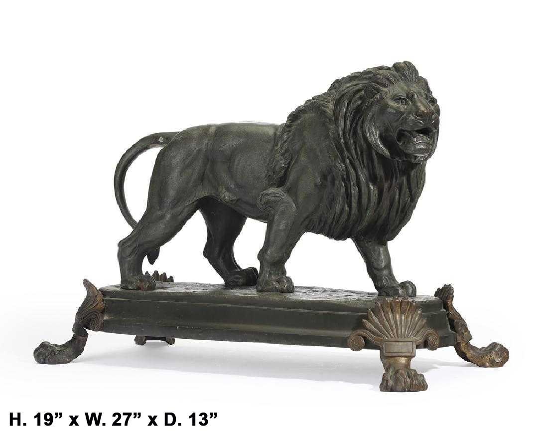 Impressive large French patinated bronze striding lion, raised on a bronze plinth, supported by four finely cast lion's feet. 
Signed E. Delabrierre.  
Late 19th-early 20th century.

Meticulous attention was given to the details of the muscles of