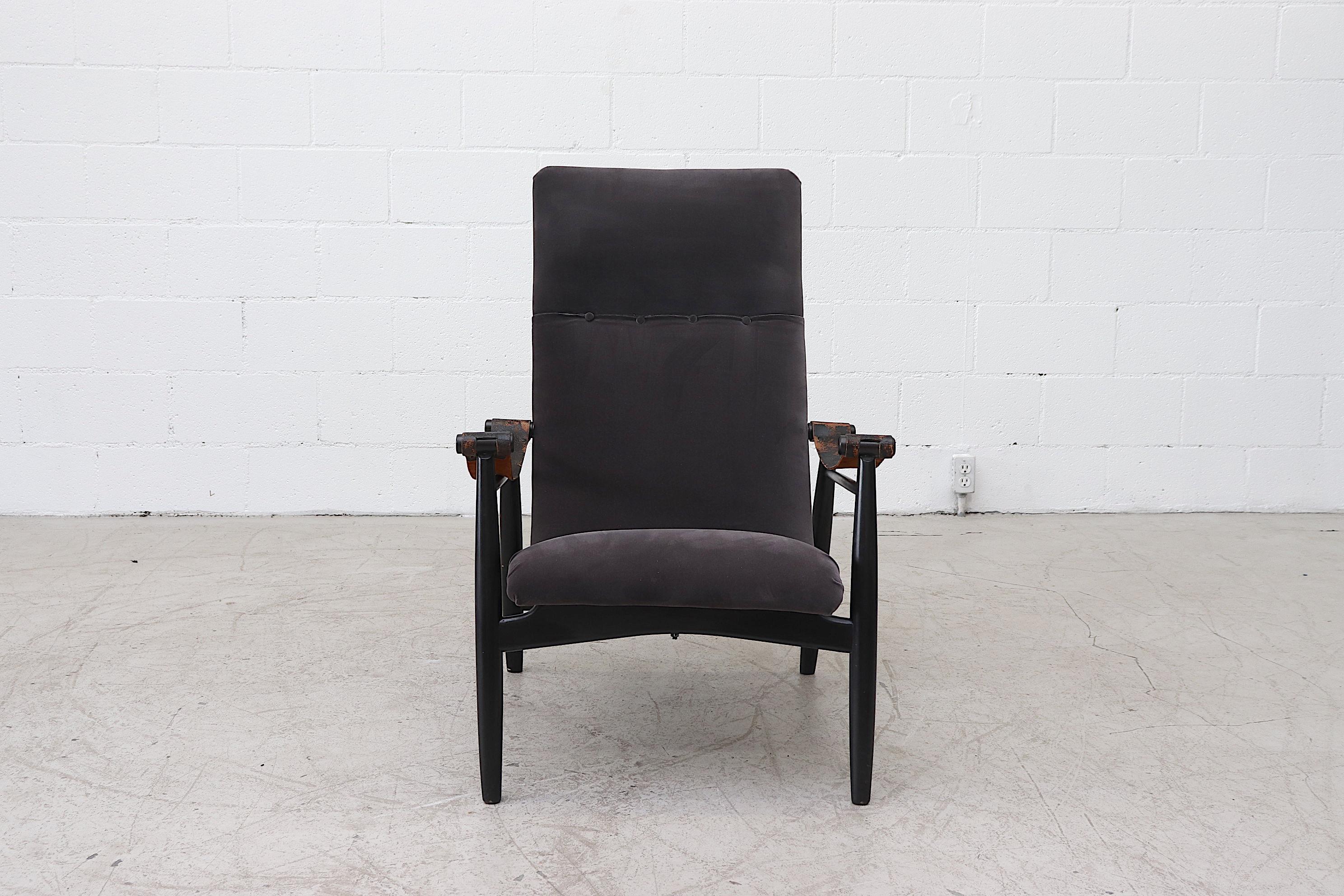 Beautifully regal Piet Muntendam lounge chair newly upholstered in dark grey velvet with lightly refinished wood frame and original leather armrest straps with visible patina and wear.