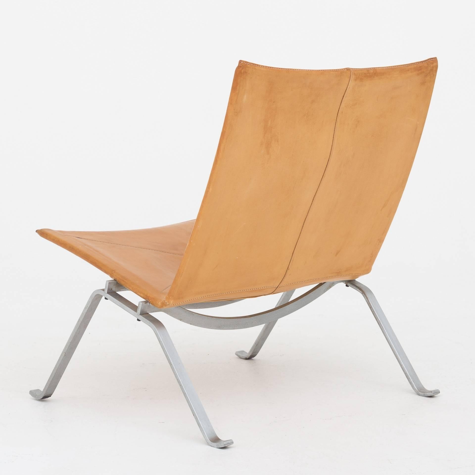 Easy chair in natural leather with steel frame. Two pieces in stock. Maker Fritz Hansen.