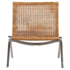 PK 22 - Easy chair in patinated woven cane by Poul Kjærholm