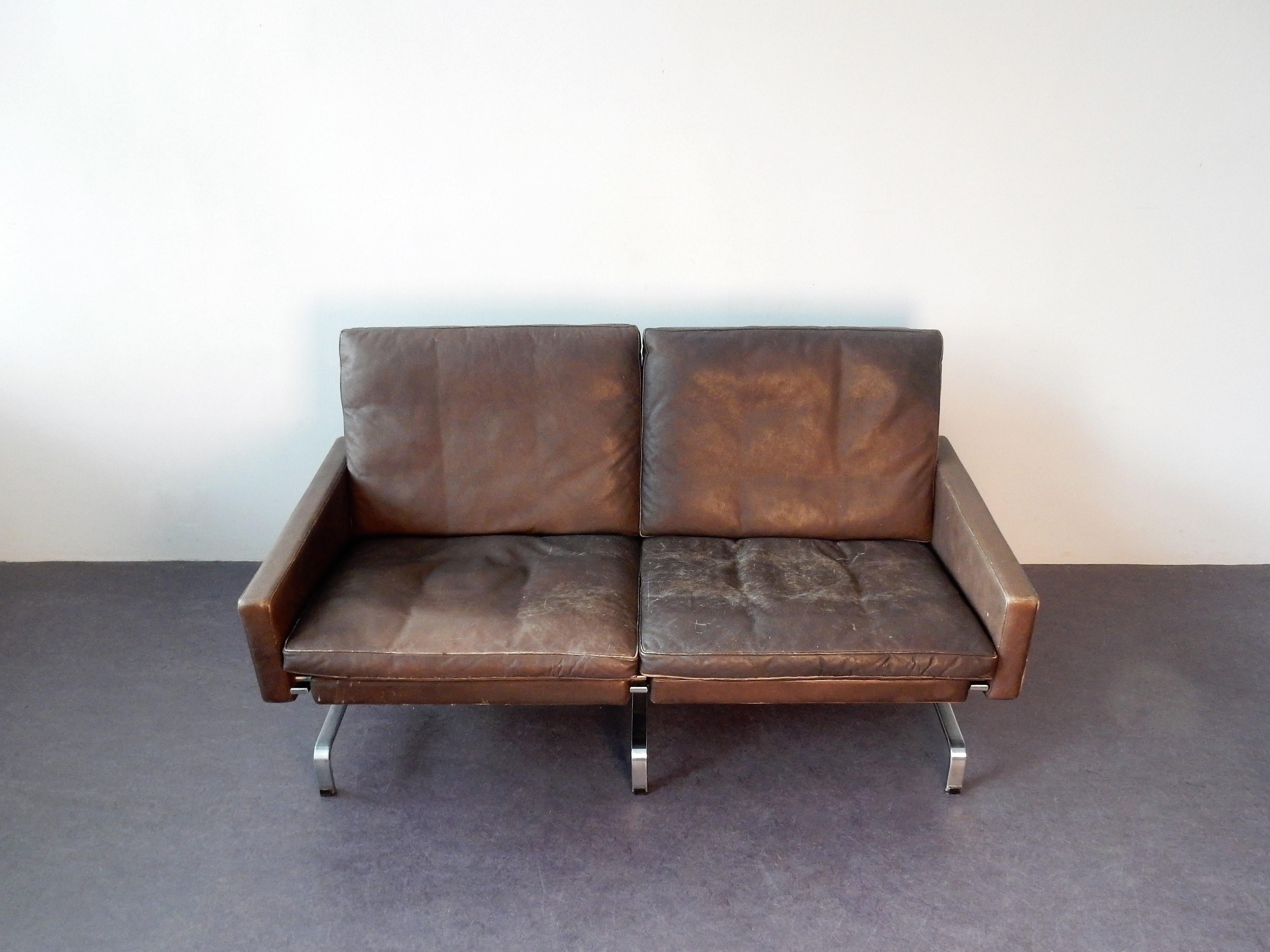This sofa comes from a bank building in Denmark. It is completely original and marked with the original marking of E. Kold Christensen on the bottom bar.
The dark brown leather has a great patina that shows age and use and tells the story of an
