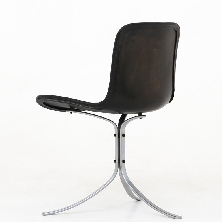 Poul Kjærholm PK 9 - Dining chair in patinated, black leather with steel frame. E. Kold Christensen.