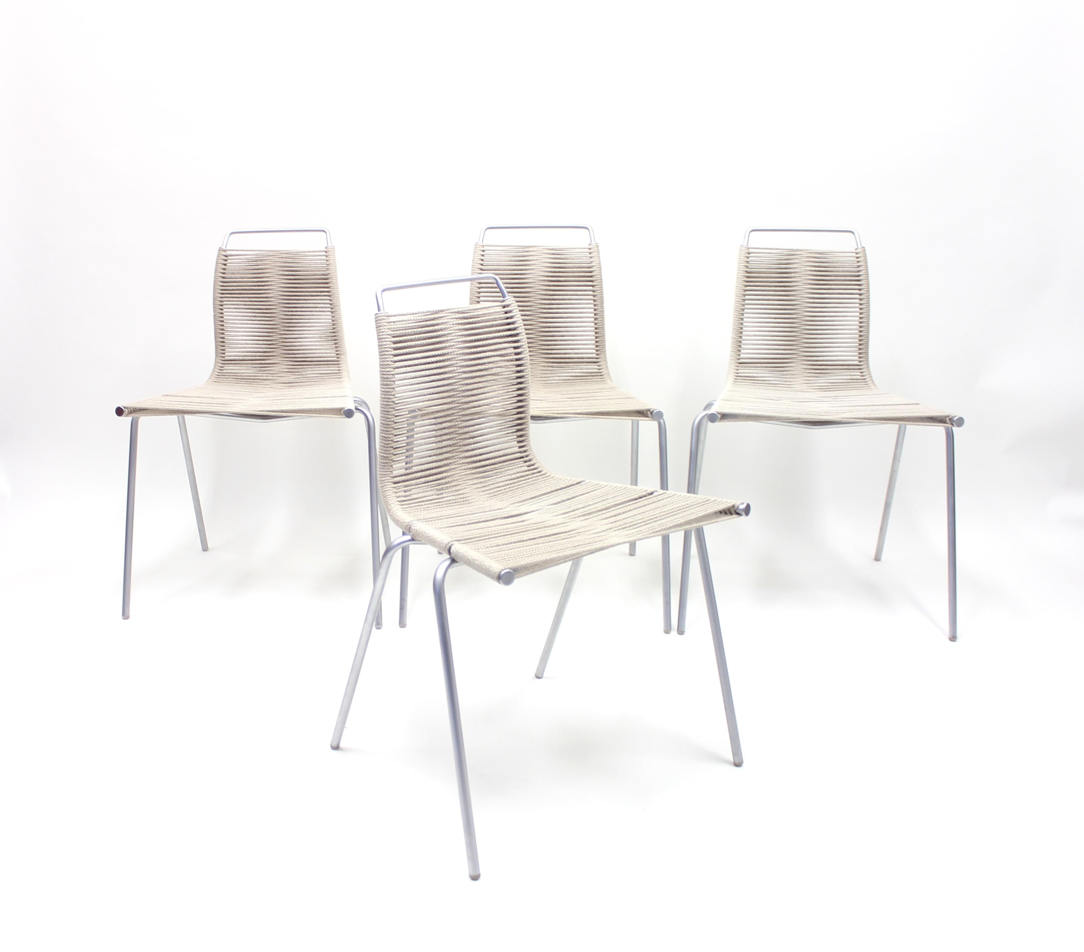 Set of four PK1 chairs designed by Poul Kjærholm and recently manufactured under licence by Thorsen Møbler in Denmark. Aluminium frame with rope seat and back. Very good condition.