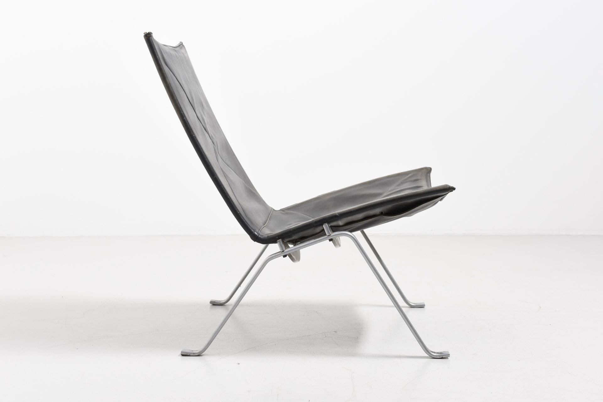 PK 22 easy chair. Design by Poul Kjaerholm in 1955. Stainless steel frame with black leather. Leather is damaged on one corner. Produced by E. Kold Christensen in Denmark.