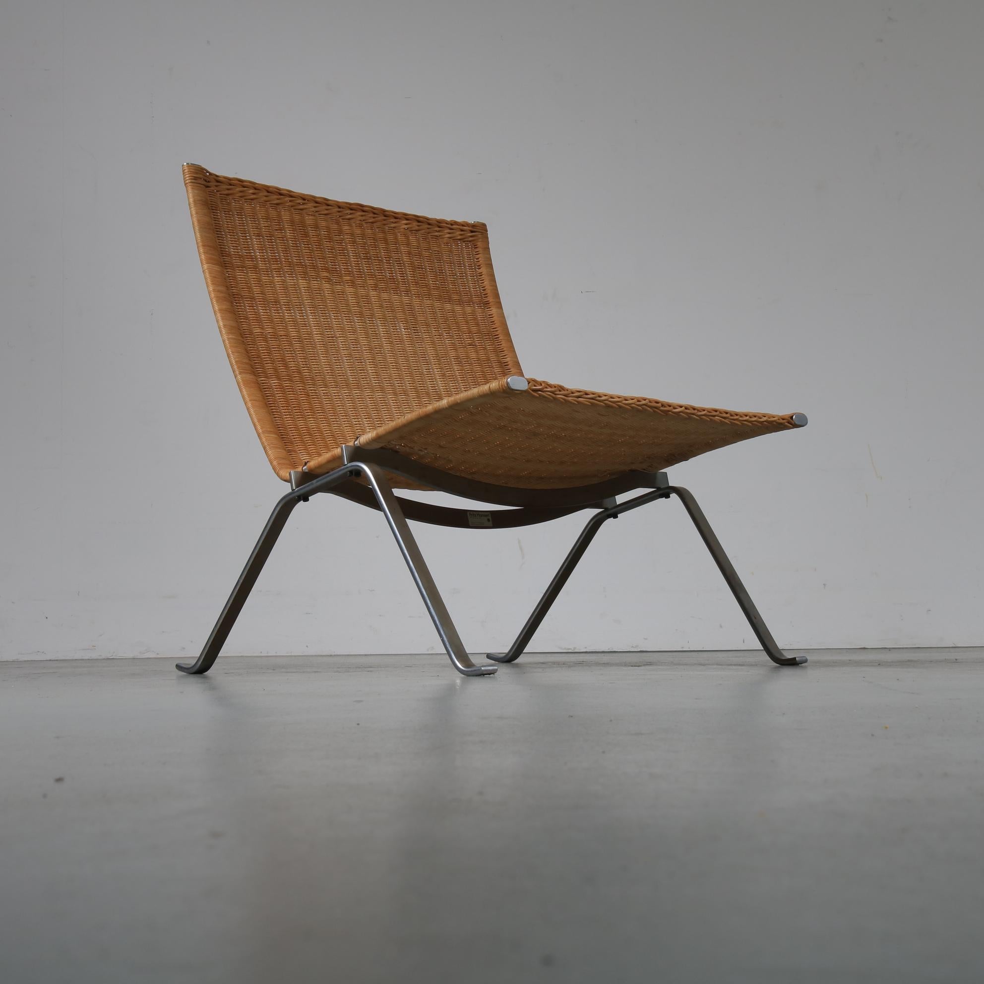 A stunning PK22 lounge chair, designed by Poul Kjaerholm, manufactured by Fritz Hansen in Denmark, circa 1960.

The chair has a beautiful chrome-plated metal base. The seat is made of high quality wicker, creating a very nice contrast with the