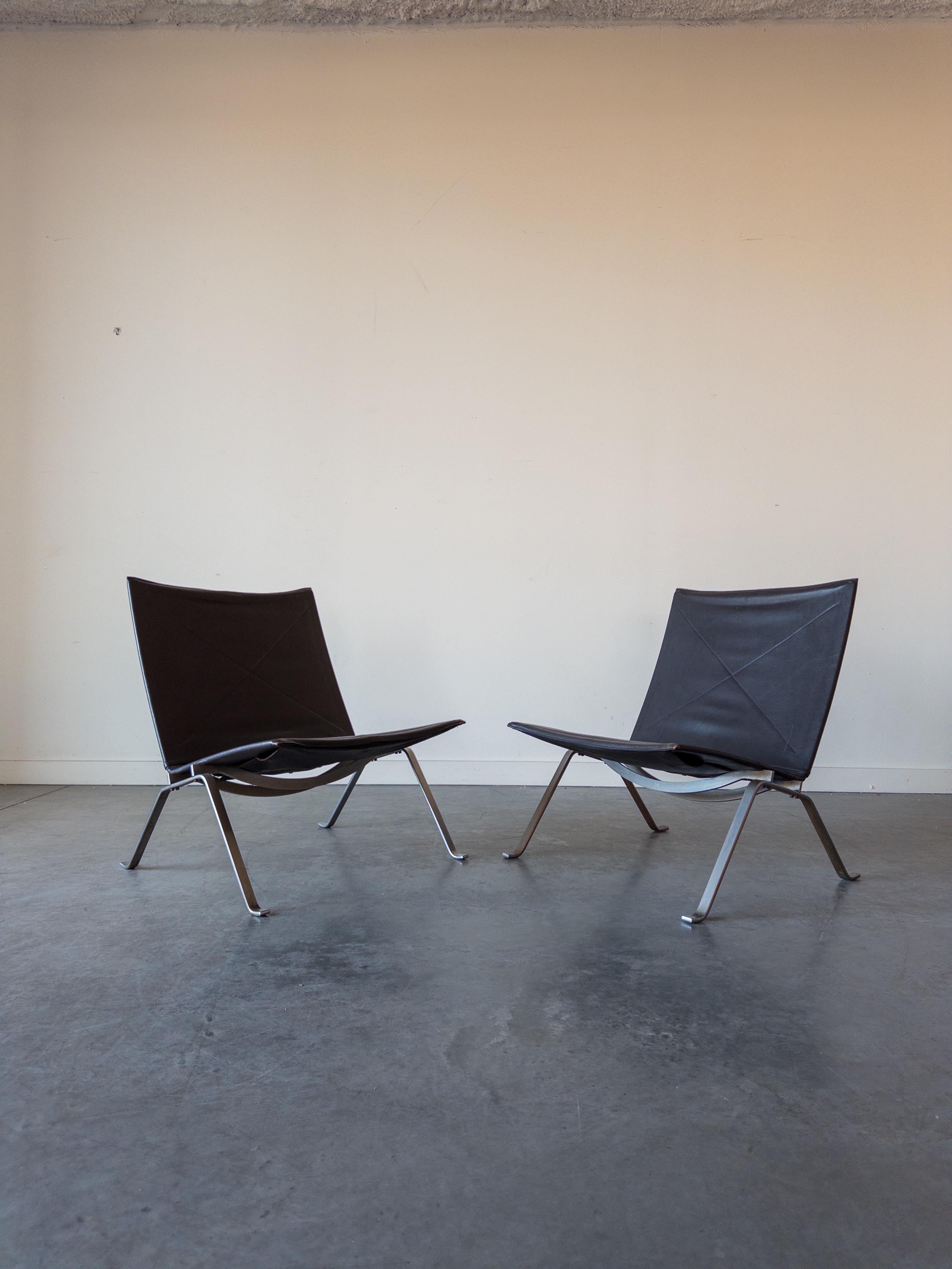 Poul Kjaerholm PK22 lounge chair in brown naugahyde
leather and stainless steel, produced by E Kold Christensen of Denmark. This is an early example, dating to the 1960's. It is in lovely original condition with original wicker material. This PK22