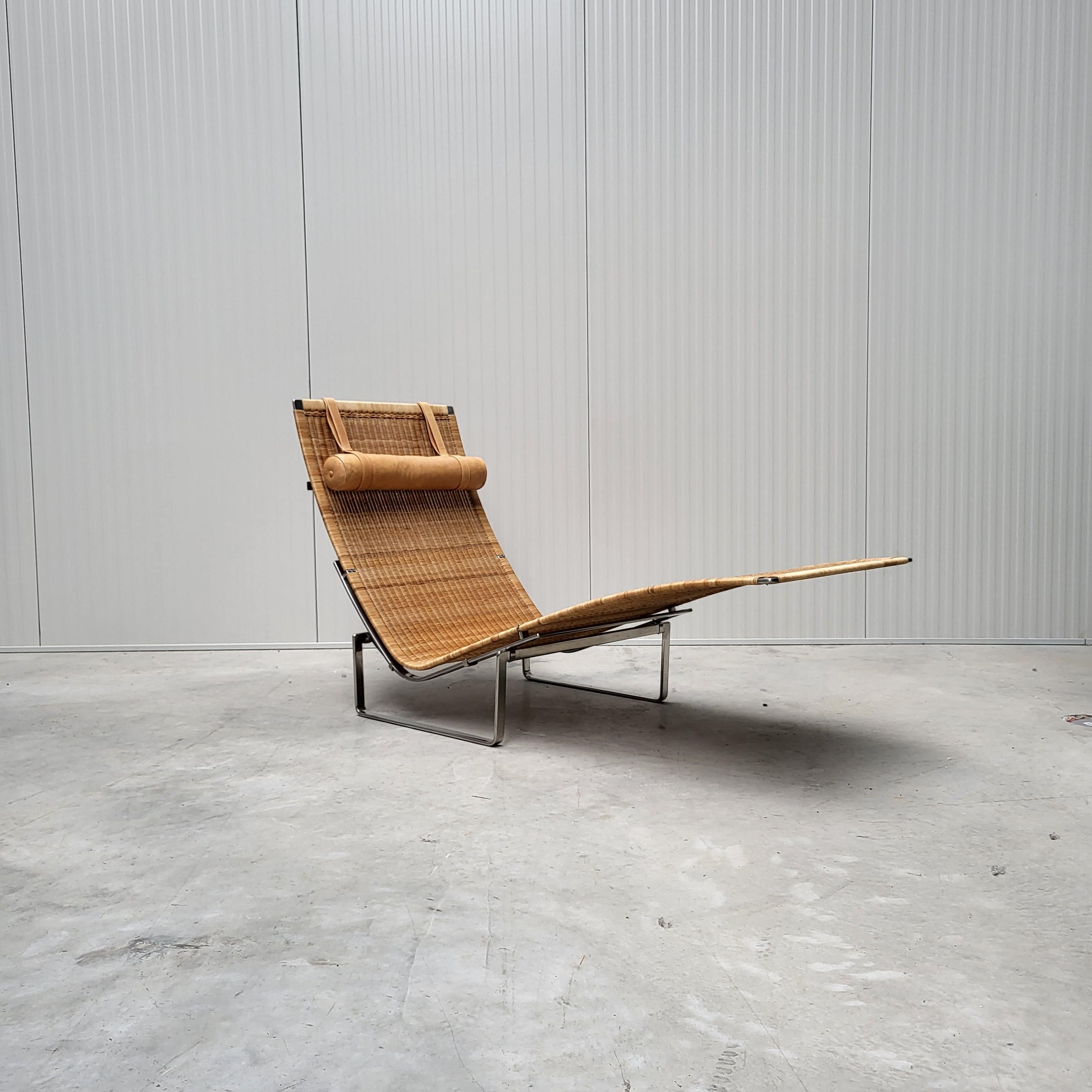 This wonderful example of the PK24 wicker chaise longue was designed by Poul Kjaerholm in the 1960s and was produced by Fritz Hansen in Denmark in 2001.

The chaise features a polished steel frame and a wicker covering, both of which are in an