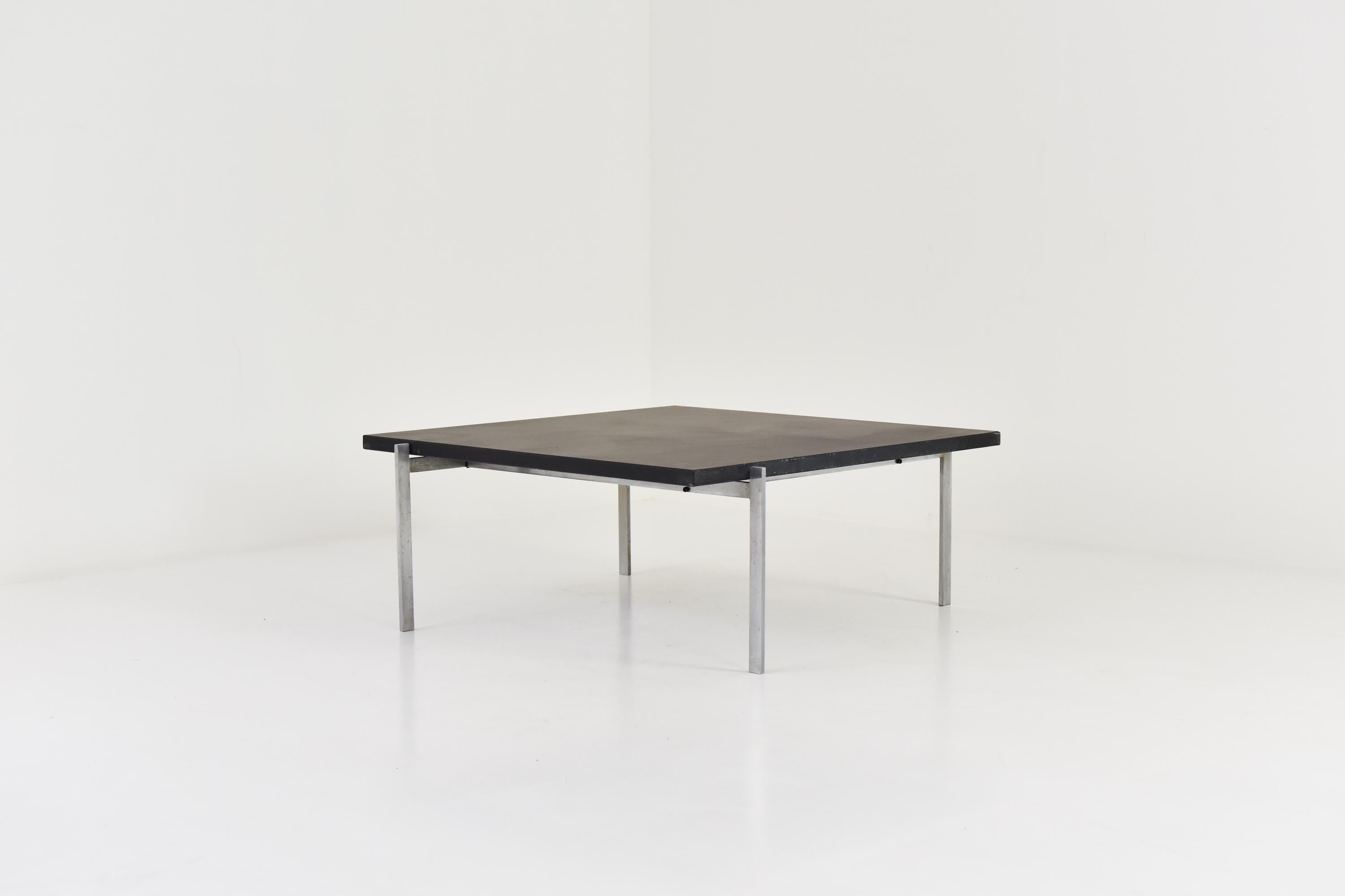 Square coffee table by Poul Kjaerholm for Fritz Hansen, Denmark, 1986. This is model PK61 and features a black slate stone and a matte chrome-plated steel frame. Designed in 1956 and still in production today. Some age related marks on the slate