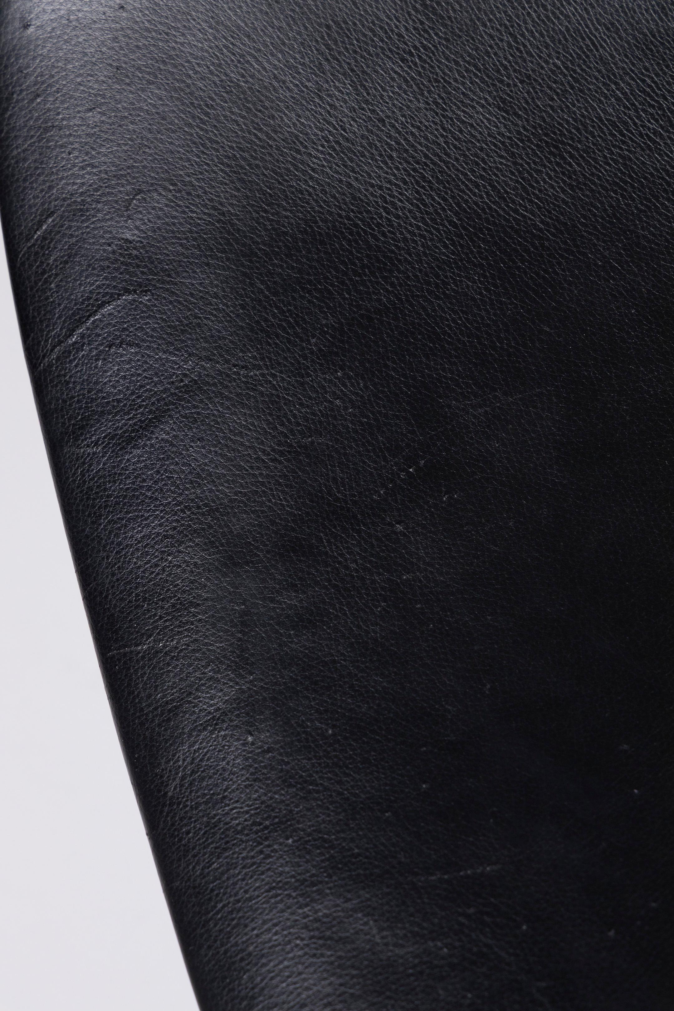 “PK9” chair designed by Poul Kjærholm for Fritz Hansen in the 1960s. The chair is fully upholstered in black leather and the base is in brushed stainless steel. Also called 