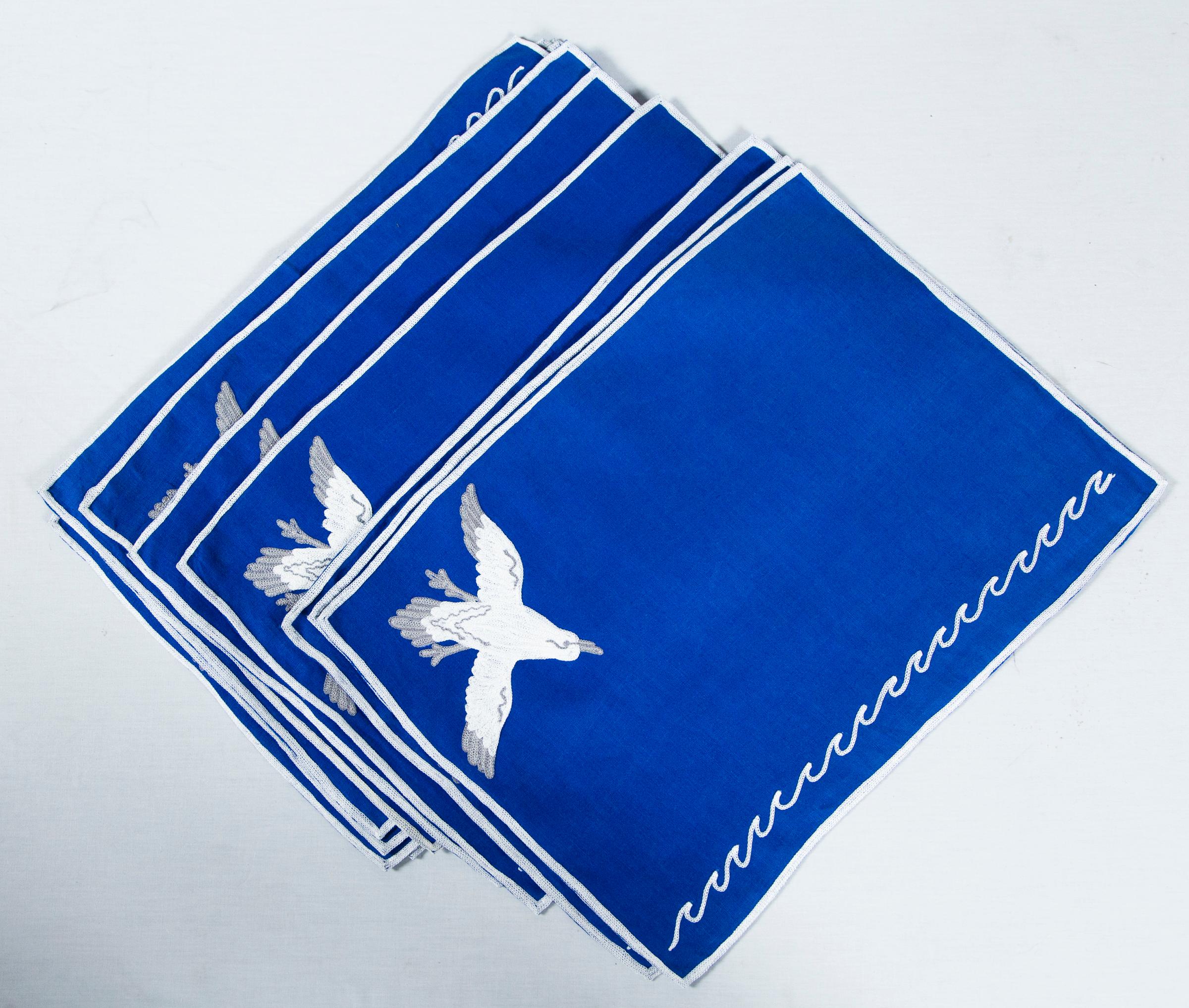 Set of superb midcentury embroidered indigo linen placemat and napkin set with a pope motif.
