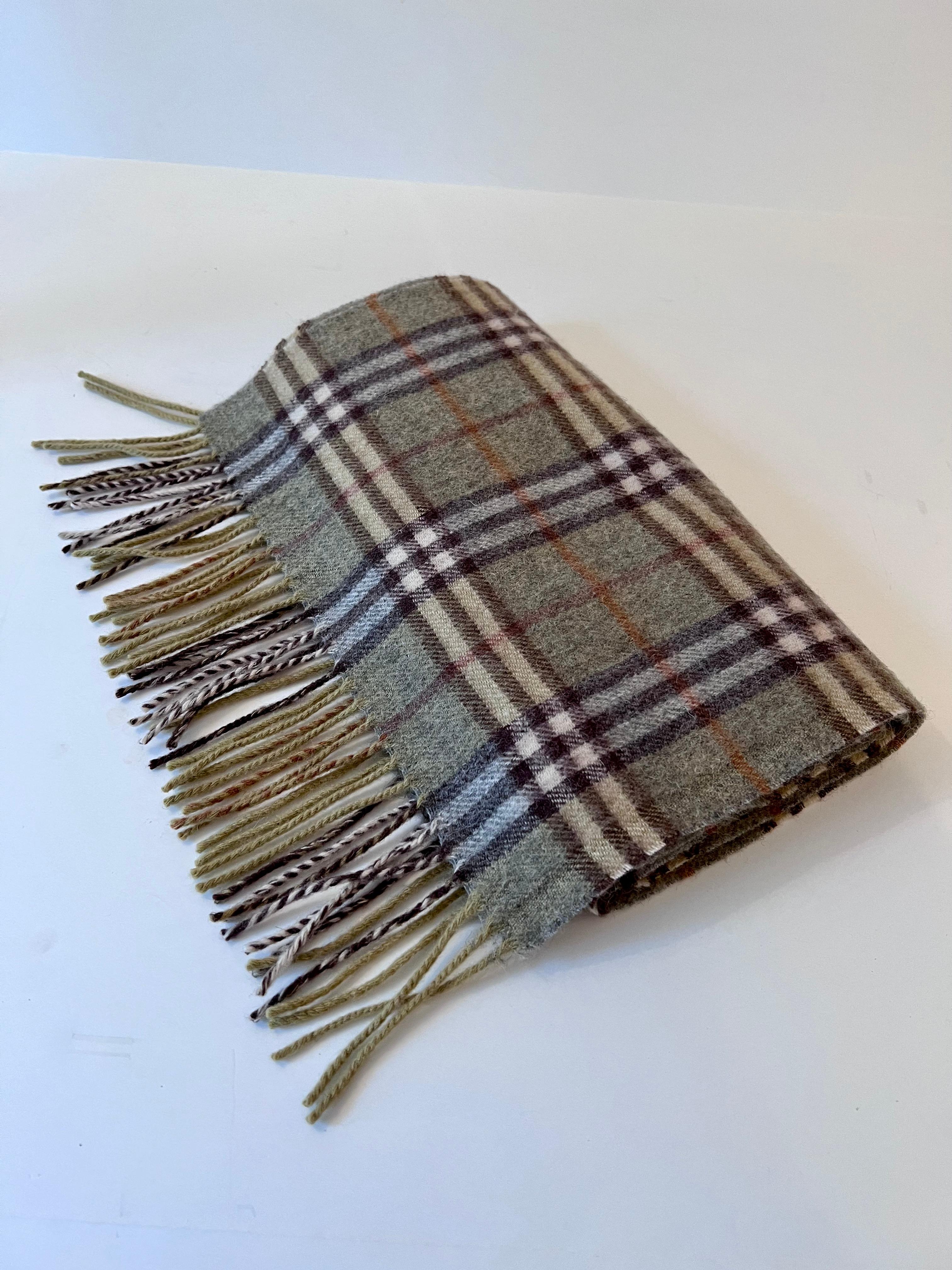 Original Burberry London Scarf of 100% Cashmere. Bluish Gray and versions thereof with fringe, Burberry label stitched on and in tact.. Has been previously owned but in excellent condition.