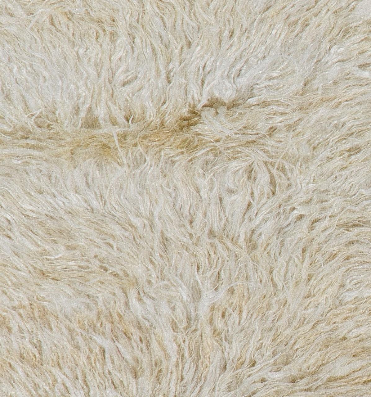 A Hand-knotted shag pile rug made of natural undyed mohair derived from local “Angora Goats” that are famous for their soft, lustrous long fleece. 

The rug is available as seen or if requested, it can be custom-produced in a different size, color