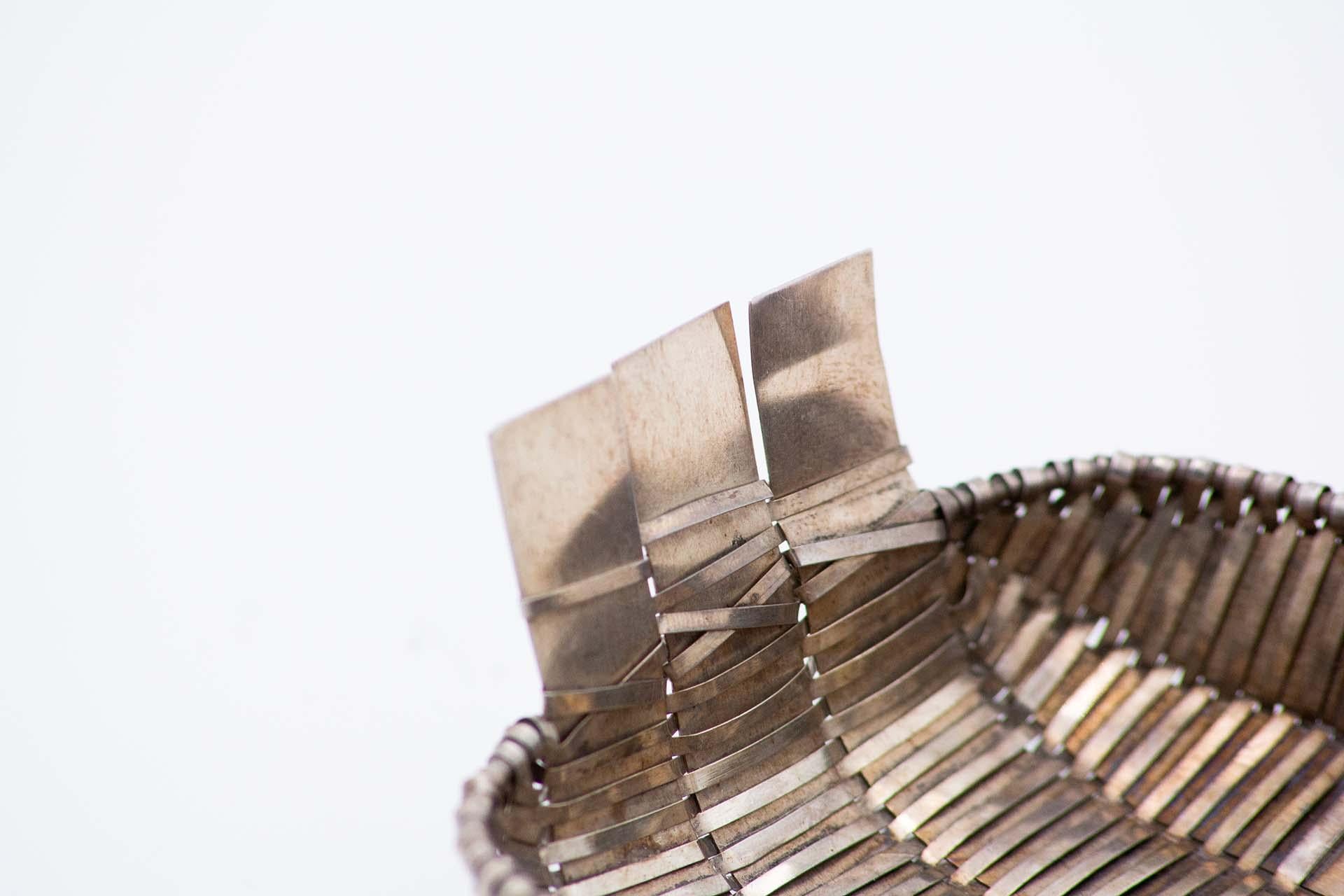 Description: Plain silver basket with raised handles. Metal: Silver. Origin: Portuguese. Brand: boar II Title. Weight: 92.03 grams. Dimensions: 14.3cmx4.9cm. Content: 833/1000. Assay Mark: Yes, between 1887 and 1937. Additional information: Good