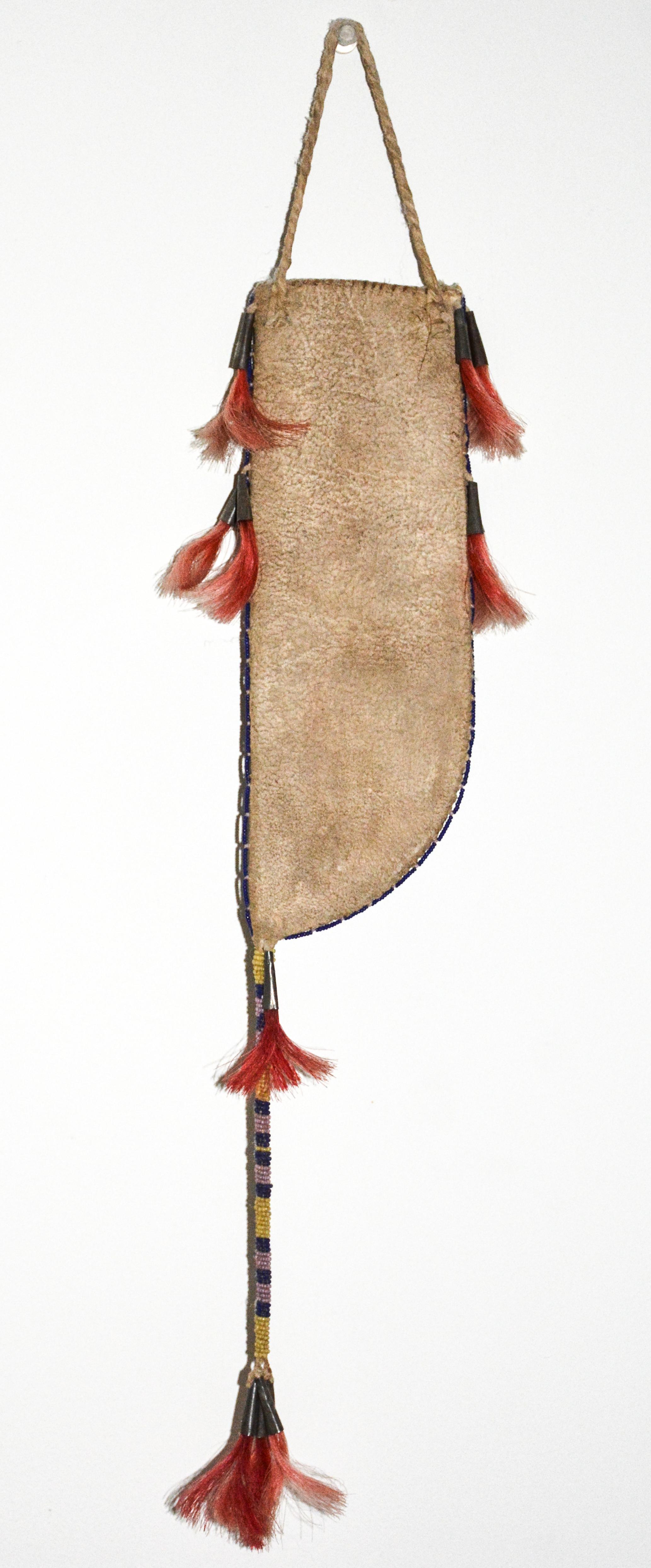 Beaded Knife Sheath

Plains

1930s

Cut glass trade beads, hide, sinew, tin cones, twisted hide, dyed horsehair.
Excellent original condition, some miner fading of the dyed horsehair.
 