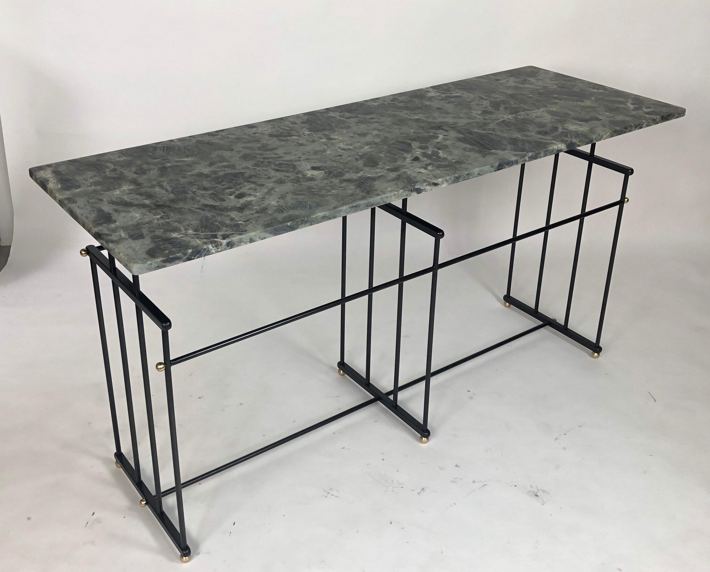 Art Deco inspired console table. Steel frame with a gun metal patina and brass accents. The top has an exceptional marble top. Black, grey with blue and silver crystalized marble. Customization possible. Custom sizes and marble top options.