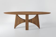 "Planalto" oval dining table in natural walnut wood