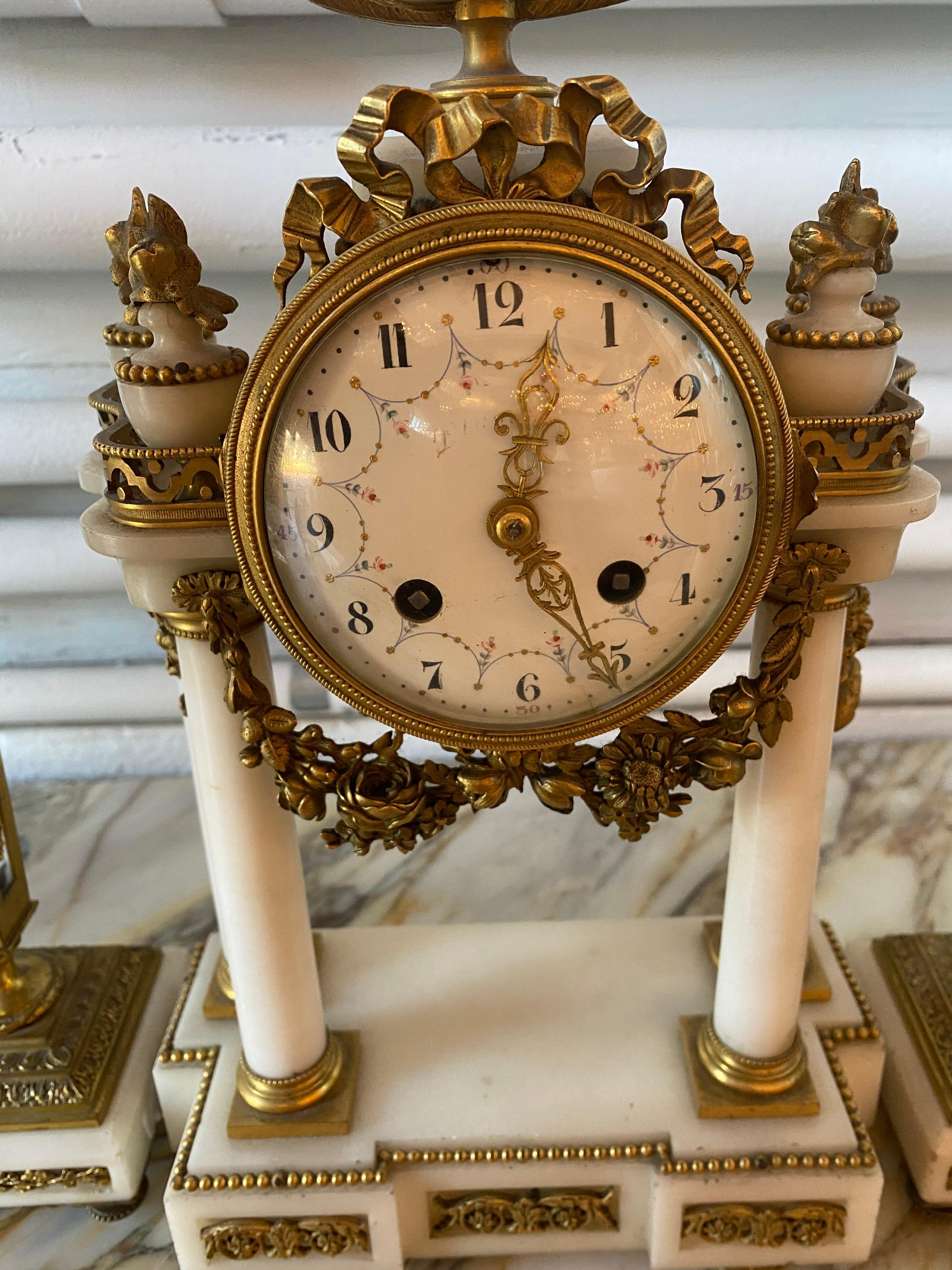 Planchon, Paris Japy Freres bronze and marble clock set. The candlesticks has a crystal inside the column. Clock.
Measures: Clock: 15 7/8” H x 8 3/4” W x 3 7/8” D. Candlesticks: 9 3/4” H x 3 1/2” W x 3 1/2” D.