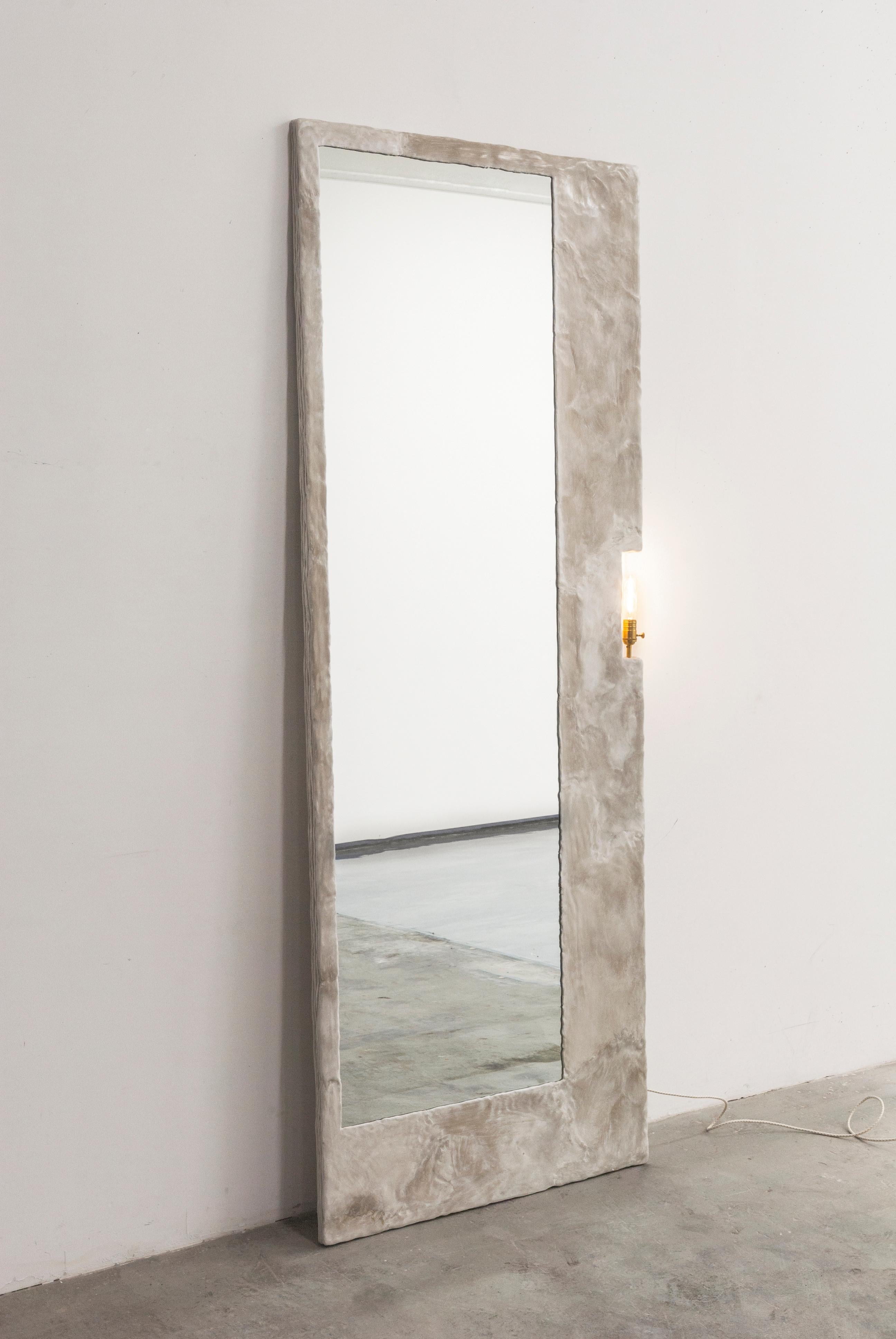 This full size mirror by Bailey Fontaine functions as both a mirror and a floor lamp. The work functions both as a utilitarian and practical piece for your space, and at the same time fulfills a sculptural aesthetic. As an emerging furniture
