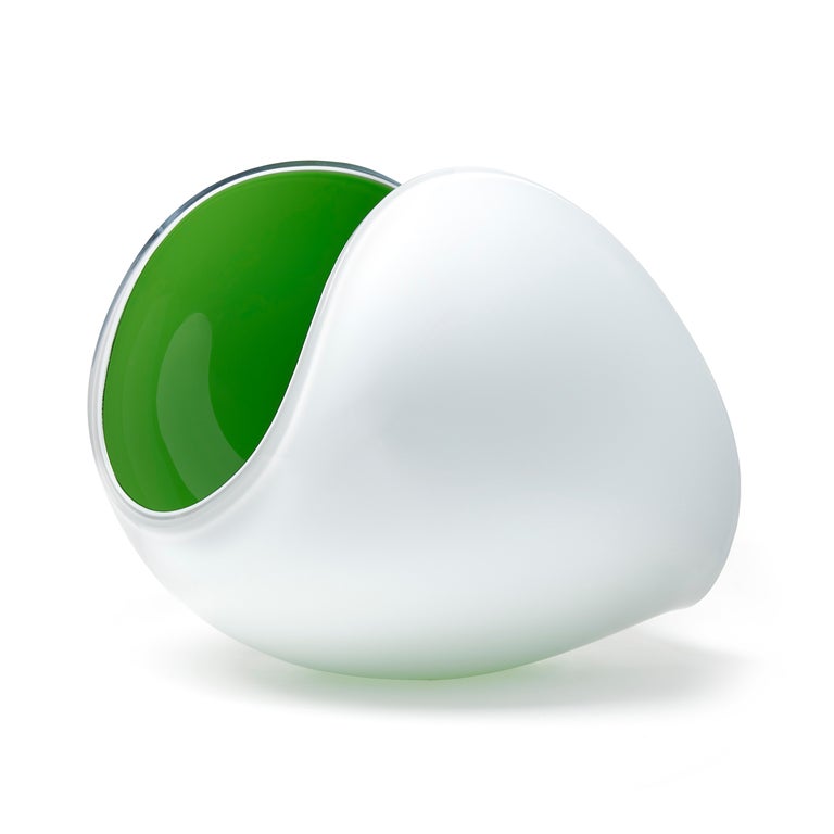 Planet in White and Apple Green is a unique glass sculptural artwork and centerpiece by the Swedish artist Lena Bergström. This piece is from an ongoing collection of works called the Planets which the artist has revisited several times throughout