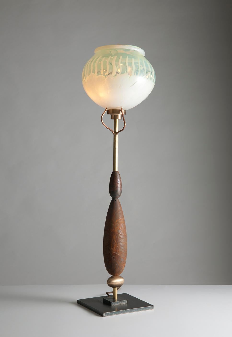 Planet lamp by Sema Topaloglu
Dimensions: 110 x 22 cm
Materials: iron with wooden, brass and iron details, shades are handblown glass

Sema Topaloglu is known for her dedication to materials, craftsmanship and a unique aesthetic vision. The