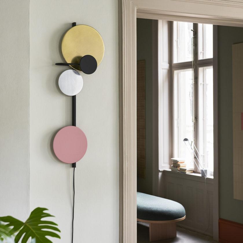 Planet wall lamp with cedar green steel, brass & aluminum disc by Mette Schelde

The discs are attached by magnets and can therefore be moved around to your liking. The indirect ambient halogen light appears soft and creates shadows on the wall