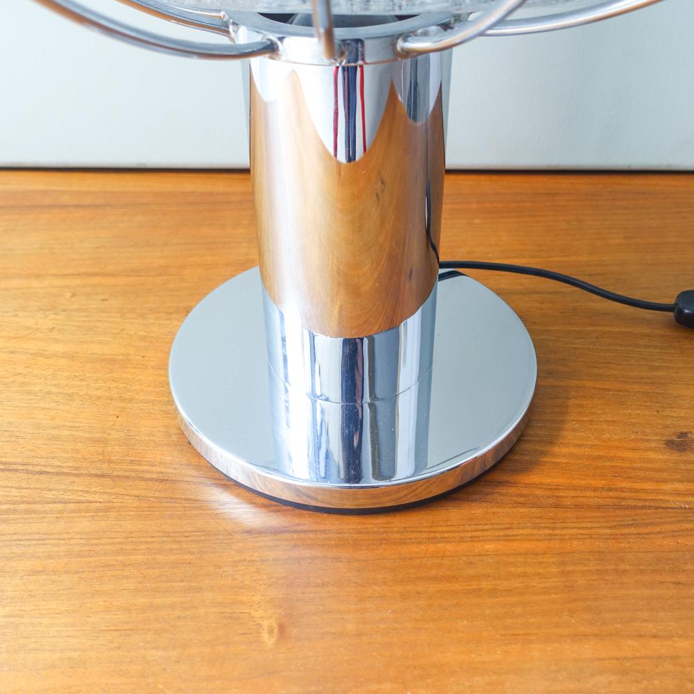 
Introducing the Planeta Table Lamp, designed by Angelo Brotto for Fase, circa 1975—a truly remarkable piece of lighting history. This lamp is a rare find, blending futuristic design with high-quality craftsmanship. The Planeta is an exact replica